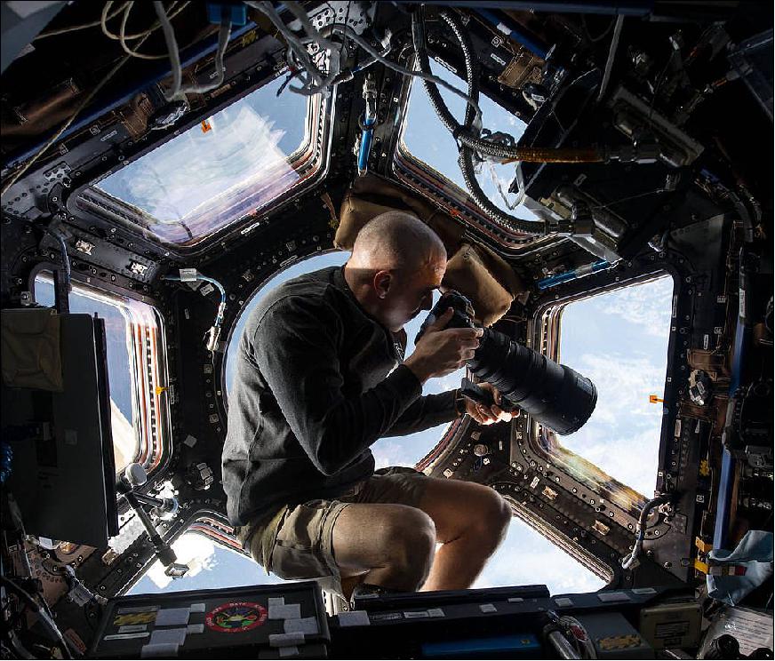 Figure 9: Inside the Cupola, NASA astronaut Chris Cassidy, an Expedition 36 flight engineer, uses a 400 mm lens on a digital still camera to photograph a target of opportunity on Earth some 400 km below him and the International Space Station. Cassidy has been aboard the orbital outpost since late March 2013 and will continue his stay into September. 17)