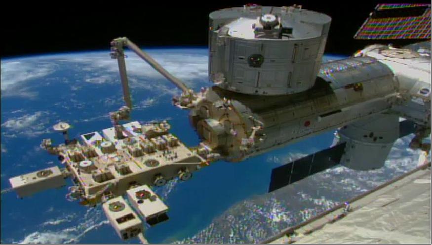 Figure 24: The Japanese robotic arm installed the CATS experiment assembly on the JEM/Kibo-EF (Exposed Facility). The SpaceX Dragon commercial cargo craft can be seen at the right center of the image (image credit: NASA TV)