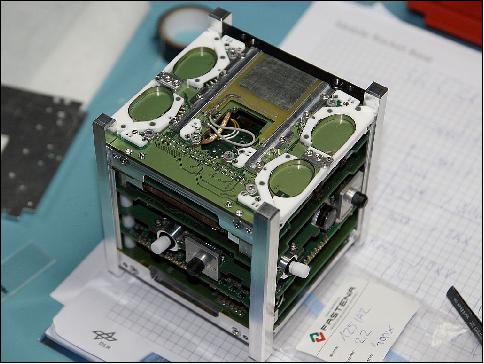 Figure 1: Photo of the skCUBE satellite with antennas wound up in ellipsoid containers (image credit: skCUBE team)
