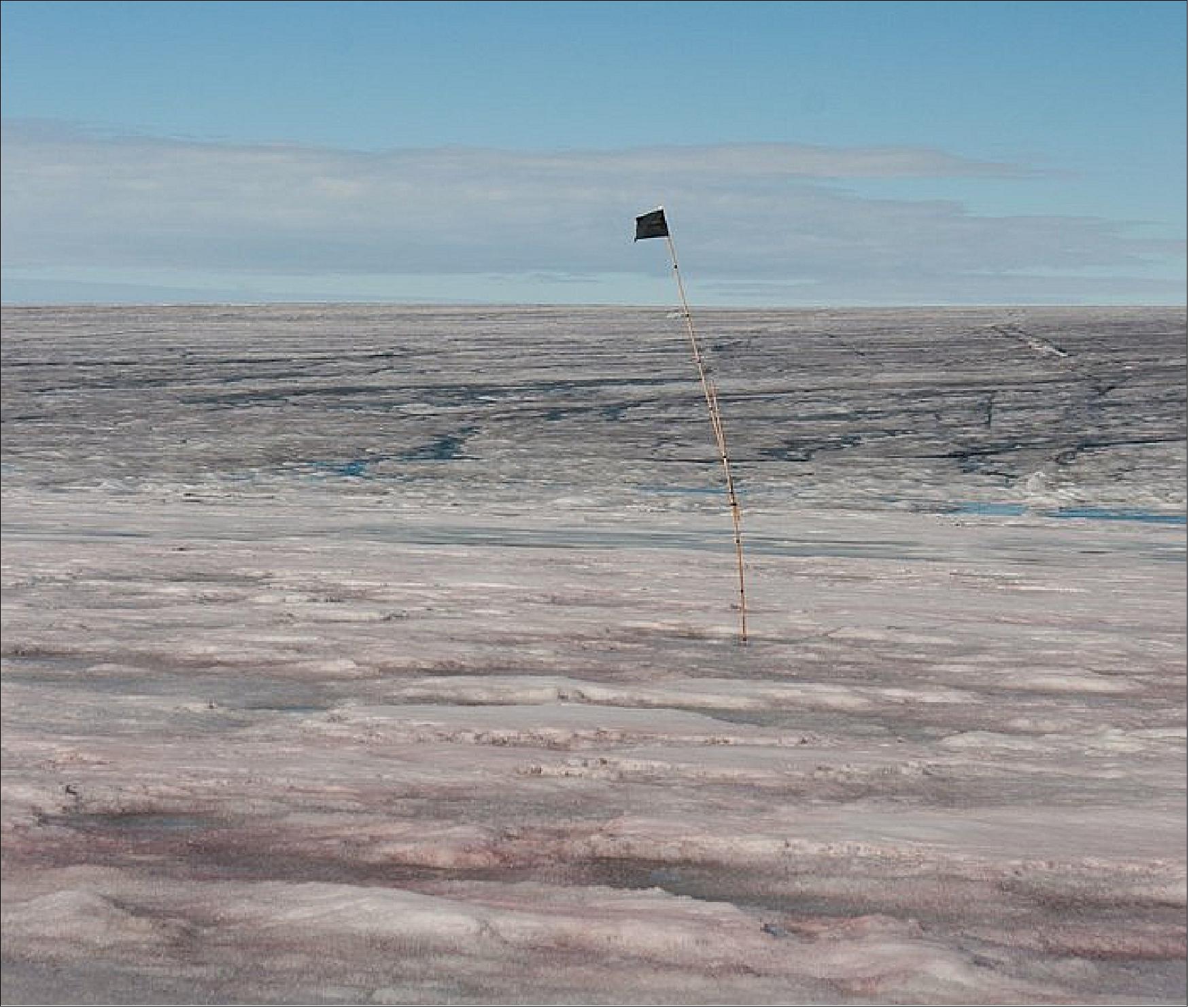 Figure 17: Polluted snow and ice on Greenland. Dark and colored impurities resurface from melting snow and lie atop water-saturated glacier ice on Greenland. Much of the colored material is biological in origin (image credit: GEUS–J. Box)