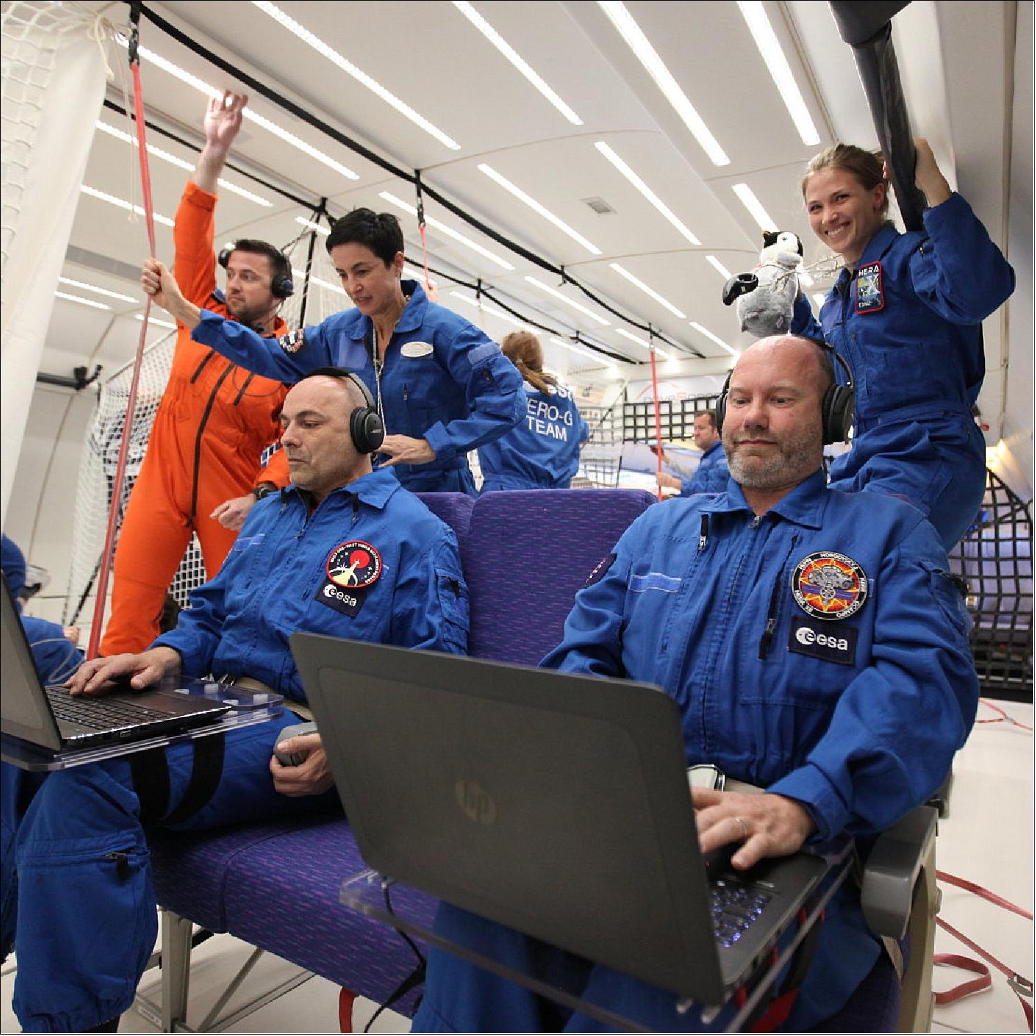 Figure 18: Two candidates test their skills on Computers during a parabolic flight (image credit: Novespace) 17)