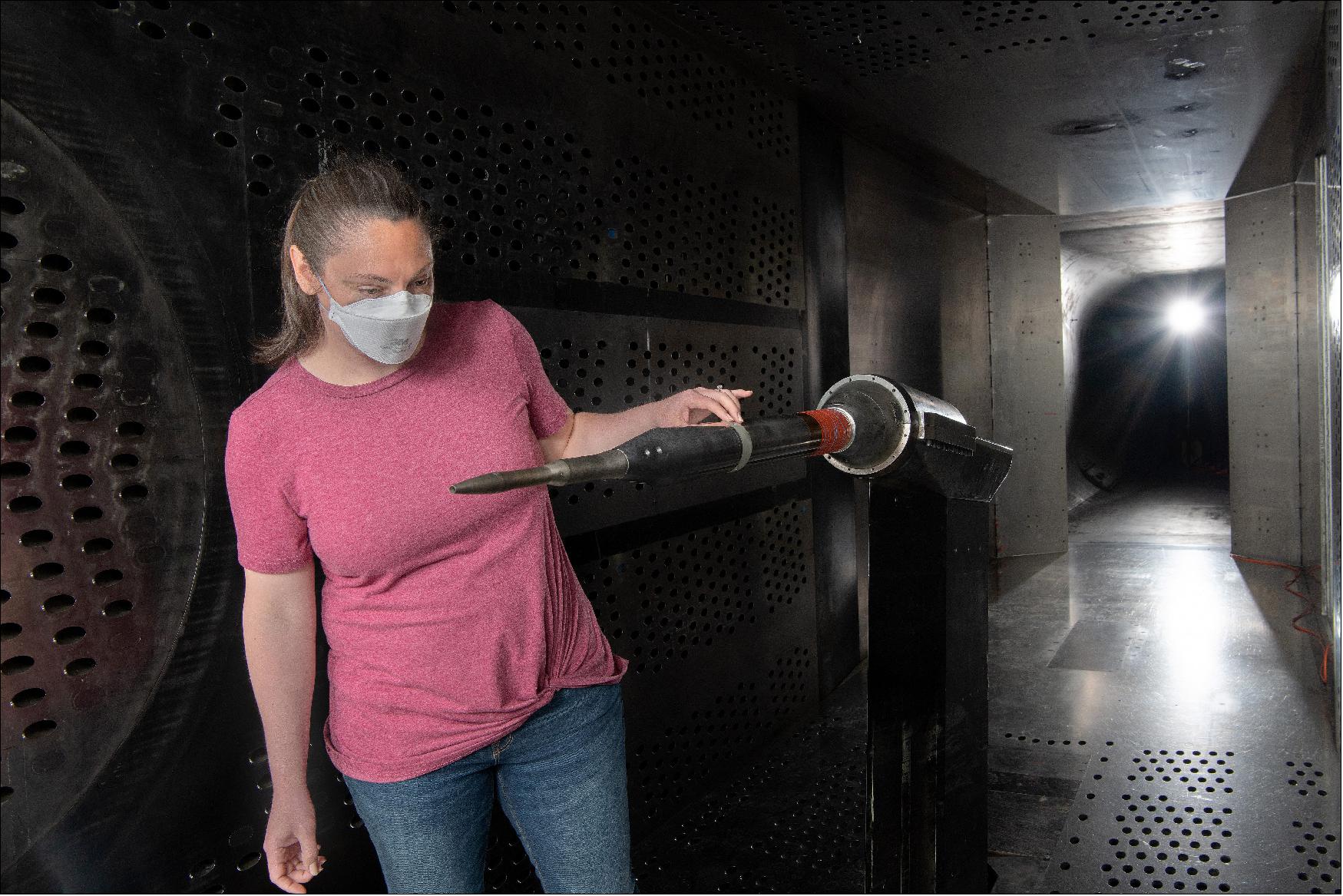 Figure 4: NASA engineer Courtney Winski inspects the X-59's air data probe at NASA's Glenn 8- by- 6-foot Supersonic Wind Tunnel (image credit: NASA)