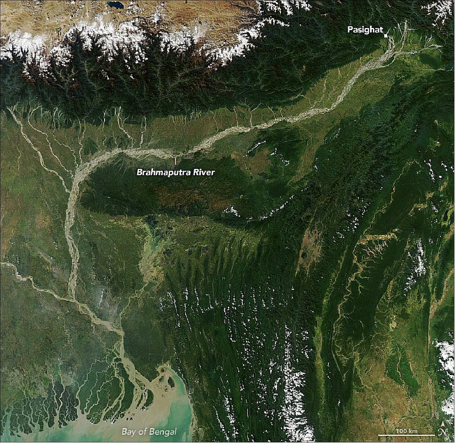 Figure 54: The river’s high sediment load contributes to the abrupt change in its shape as it exits the Himalayas and hits flatter land. The MODIS instrument on NASA’s Aqua satellite captured this natural-color image of the river on November 9, 2020. Notice how the narrow channel widens after passing the town of Pasighat, transforming into a braided river with multiple, interlacing channels. As the water slows in the flatter Brahmaputra Valley, it loses its capacity to carry sediment, depositing the excess silt in sandbars. In the course of a few kilometers, the river channel increases its width twentyfold (image credit: NASA Earth Observatory image by Lauren Dauphin, using MODIS data from NASA EOSDIS/LANCE and GIBS/Worldview. Story by Adam Voiland)