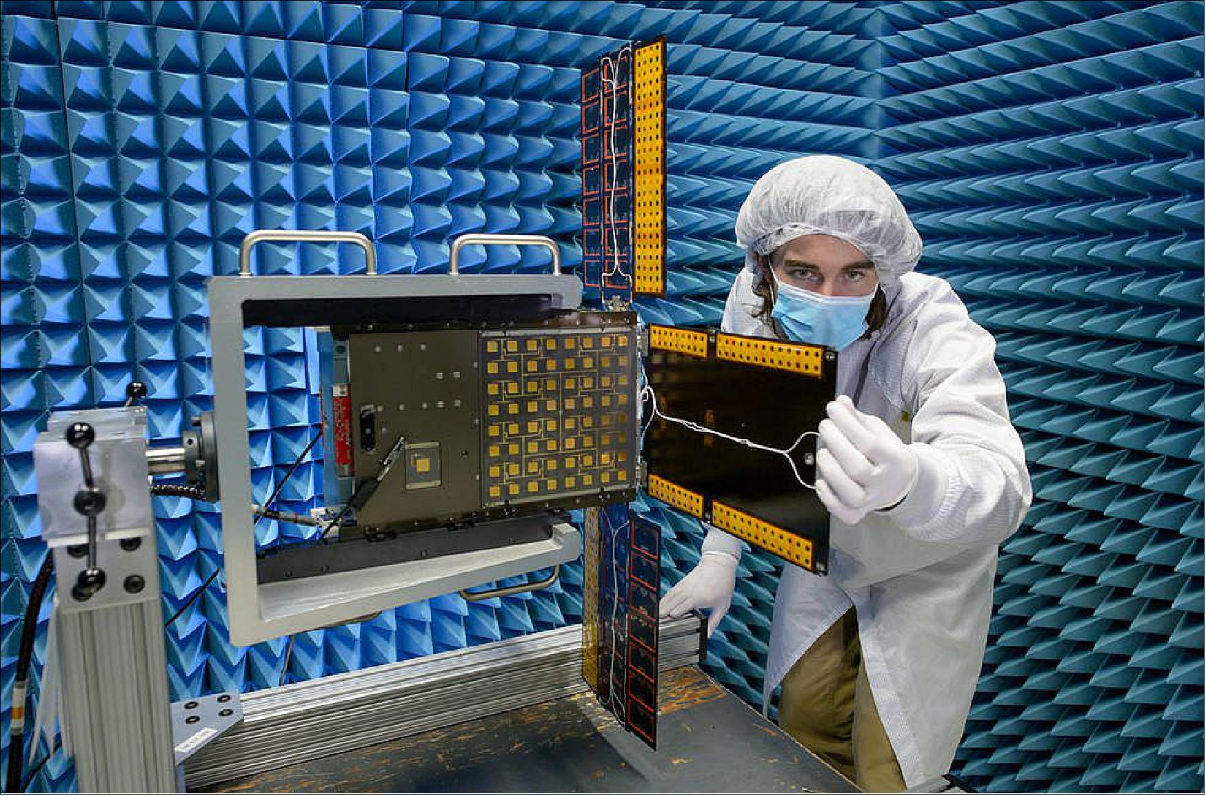 Figure 8: Here, inside an anechoic chamber at Ames, quality assurance engineer Austin Bowie inspects BioSentinel’s solar array after completion of a test to determine the effects of electromagnetic spacecraft emissions on spacecraft systems (image credit: NASA, Dominic Hart)