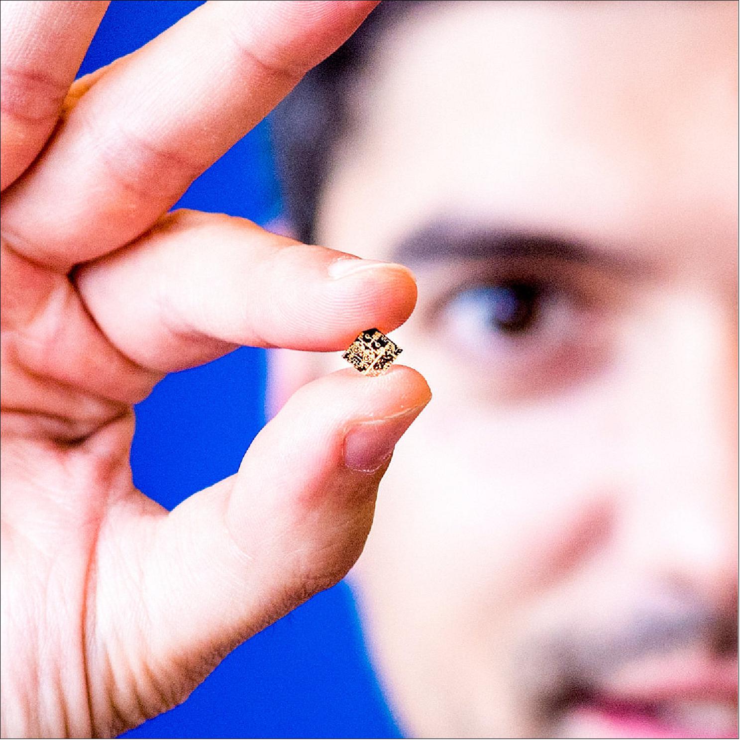 Figure 27: Natanael Ayllon, ESA payload engineer, showing a prototype transmit/receive module on a single chip (image credit: ESA - SJM Photography)