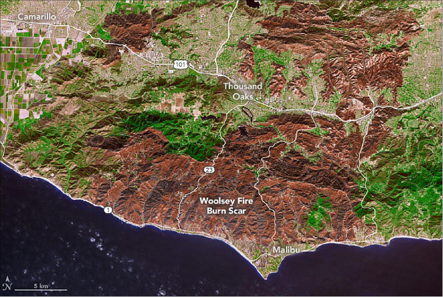 Figure 2: The Woolsey Fire burn scar, shown in red, was large enough to be visible from space, as seen in this view from NASA's Terra satellite. The colors in the image have been enhanced to simulate a more natural appearance (image credit: NASA Earth Observatory)