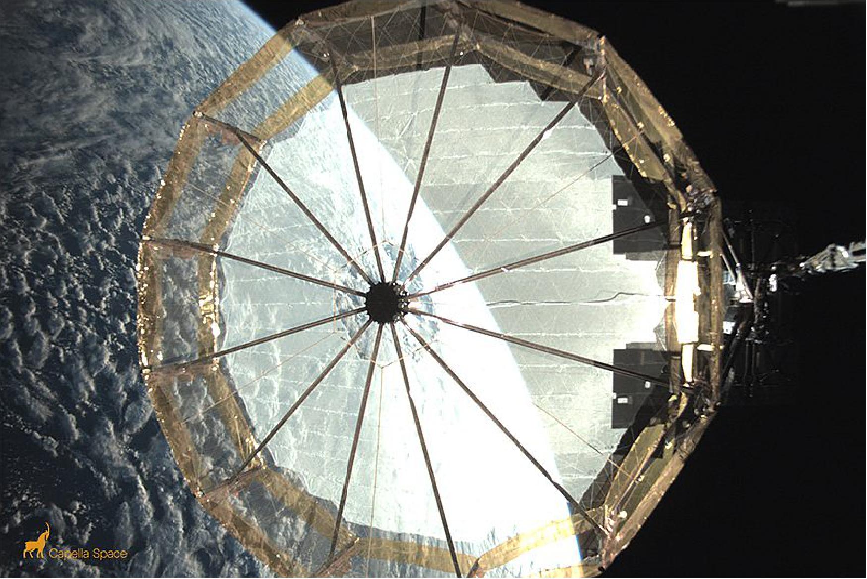 Figure 12: Reflector Antenna Deployment. Engineers deployed the antenna over a series of ground contacts, tensioning the instrument to millimeter-level precision. In this image, you can see the final deployment of our mesh-based reflector antenna. It’s designed to deliver high-contrast, high-resolution and low-noise imagery (image credit: Capella Space)