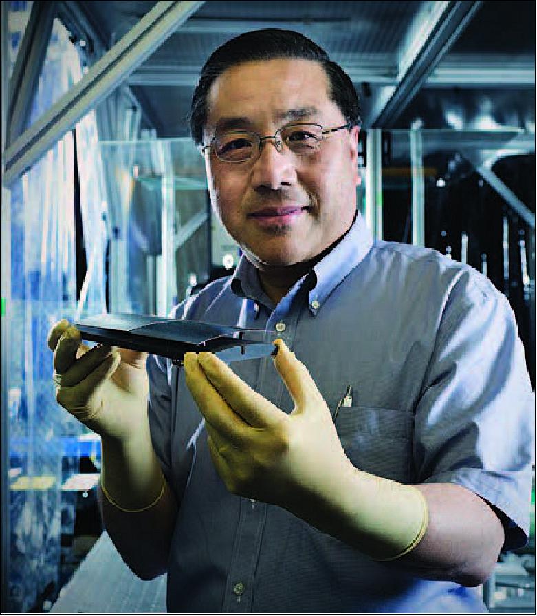 Figure 34: Goddard scientist Will Zhang holds mirror segments made of silicon. These X-ray optics have been baselined for the proposed Lynx X-ray Observatory (image credit: NASA, Chris Gunn)