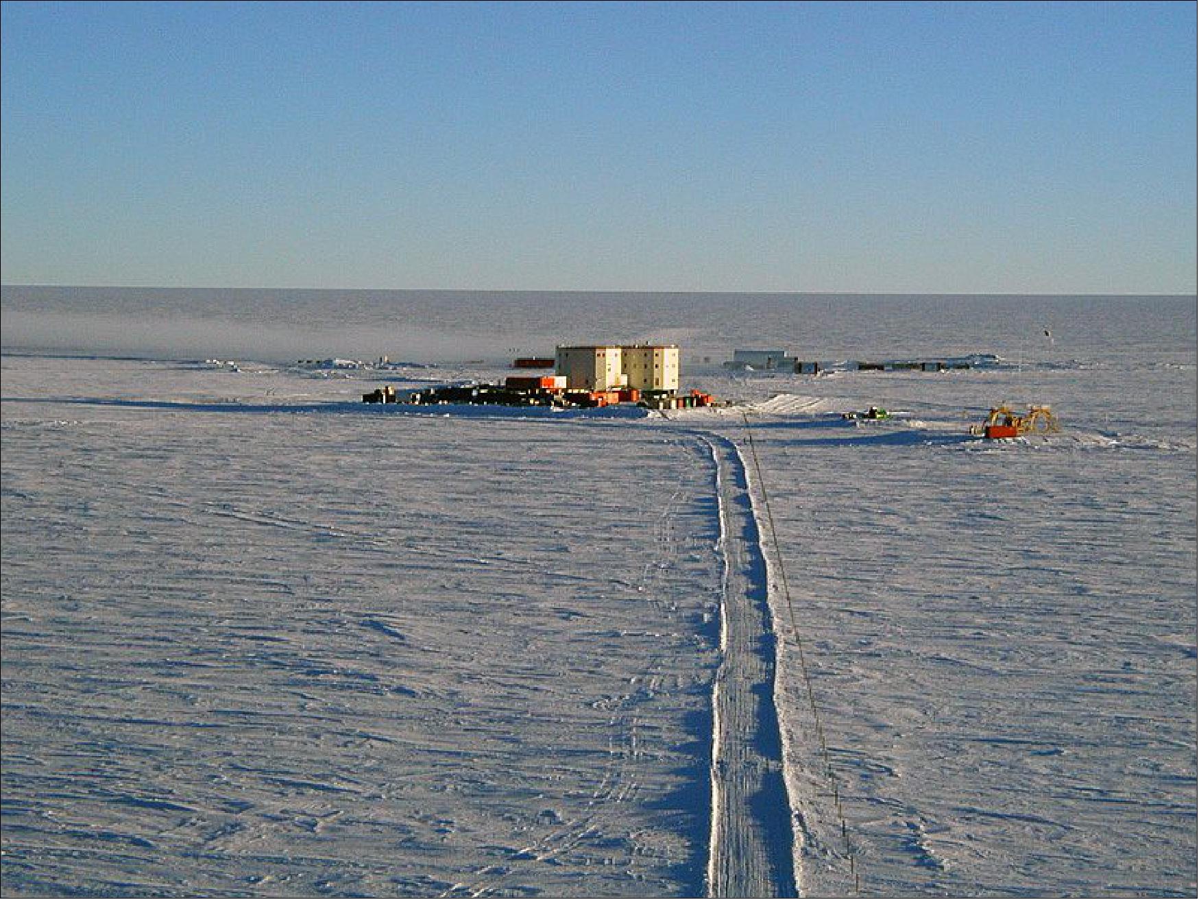 Figure 2: Photo of the Concordia Research Station at Dome C seen from the top of a 32-meter tower located about 1 km from the station. The summer station is visible behind the new (still under construction at that time) winter station. The photo was taken just after midnight on 29 January 2005(image credit: Stephen Hudson)