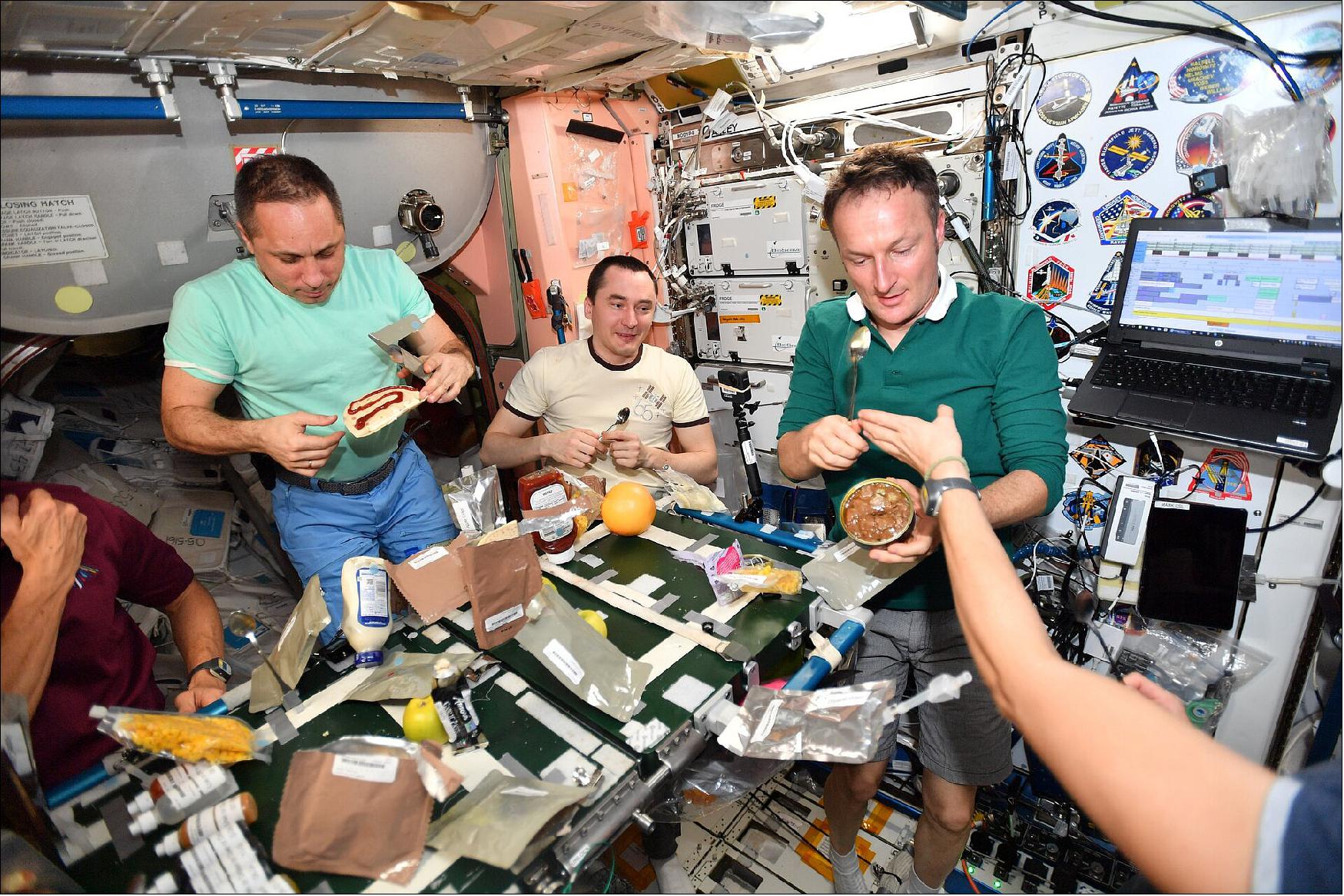 Figure 25: Sampling Rendang. Matthias celebrates American Thanksgiving together with his crew mates on board the International Space Station during his Cosmic Kiss. He posted these images to his social media on 25 November with the caption: "One of the best things about international collaboration? Sharing international celebrations and culture I'm thankful for all my crew mates up here on the International Space Station and everyone supporting our mission from Earth"