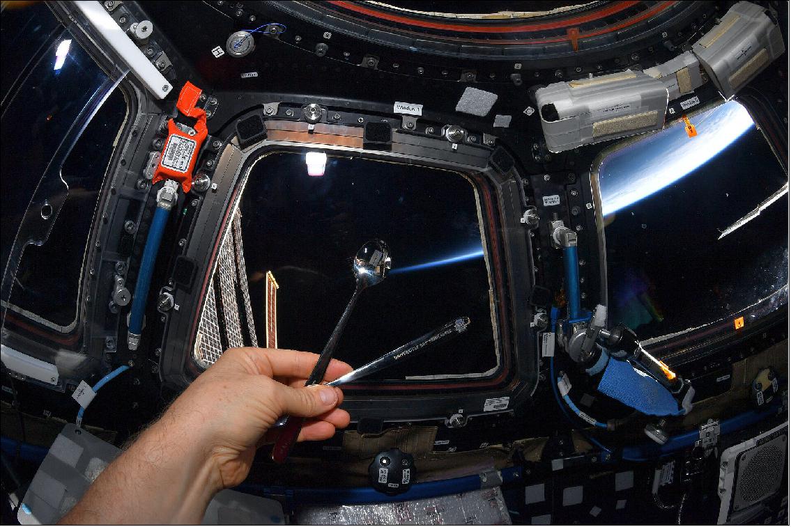 Figure 18: ESA astronaut Matthias Maurer holds a laser-structured, anti-microbial spoon developed by Saarland University, European School of Materials (EUSMAT) and Material Engineering Center Saarland (MECS). This spoon is part of an investigation into the antimicrobial properties of laser-structured surfaces (image credit: ESA/NASA)