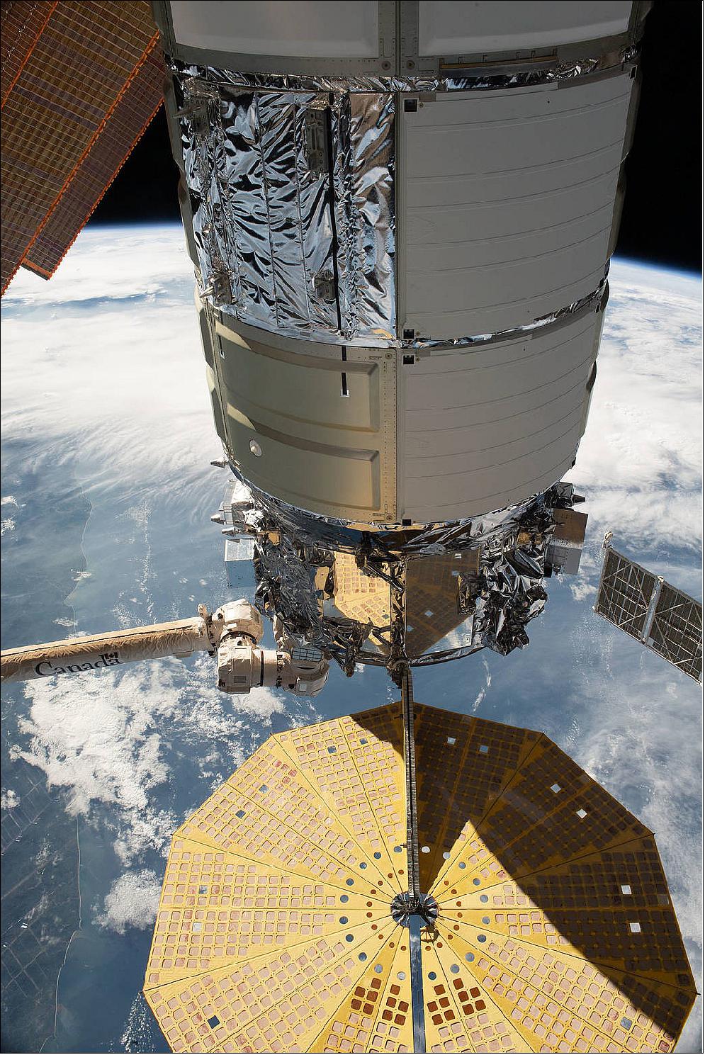 Figure 3: The Northrop Grumman Cygnus space freighter is pictured in the grips of the Canadarm2 robotic arm after it was installed on the Unity module's Earth-facing port (image credit: NASA TV,, Mark Garcia)