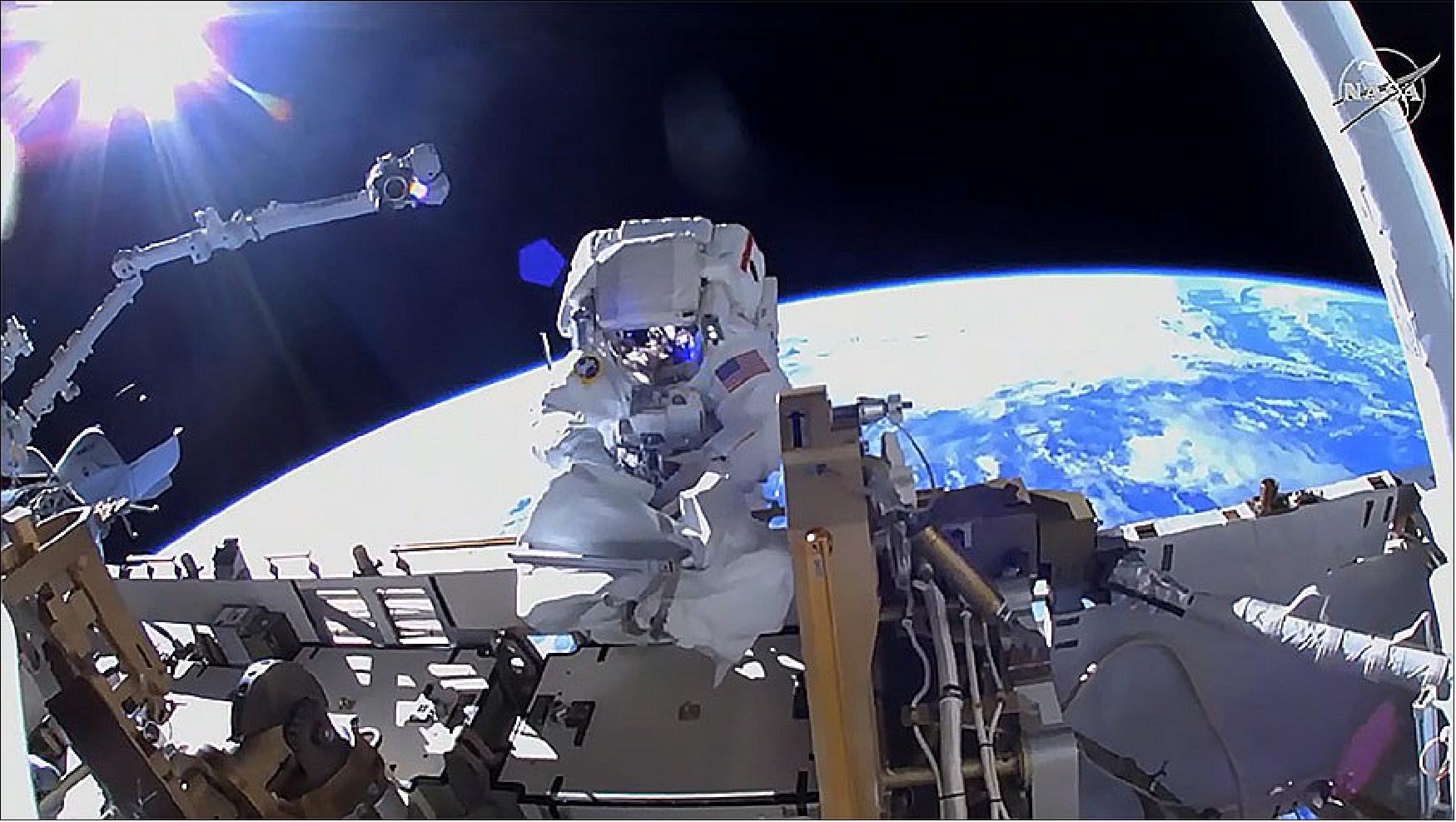 Figure 14: NASA astronaut Kayla Barron works to ready the space station for a third set of roll-out solar arrays about 260 miles above the Earth (image credit: NASA TV)