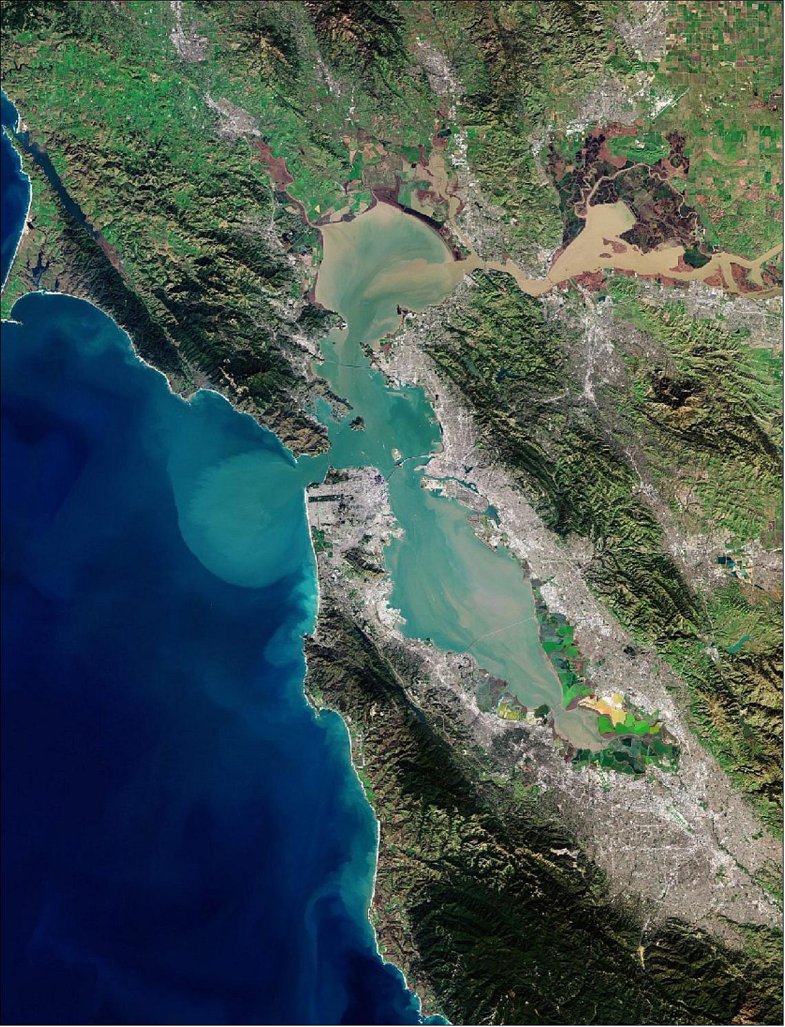 Figure 39: In the upper right of the image, the delta of the Sacramento and San Joaquin rivers is visible – with the brown, sediment-filled water flowing down into San Pablo Bay. Here, the murky waters mix before flowing into the larger bay area, which is connected to the Pacific Ocean via the Golden Gate strait. A large sediment plume can be seen travelling westward into the Pacific in the left of the image. This image, captured on 25 January 2019, is also featured on the Earth from Space video program (image credit: ESA, the image contains modified Copernicus Sentinel data (2019), processed by ESA, CC BY-SA 3.0 IGO)