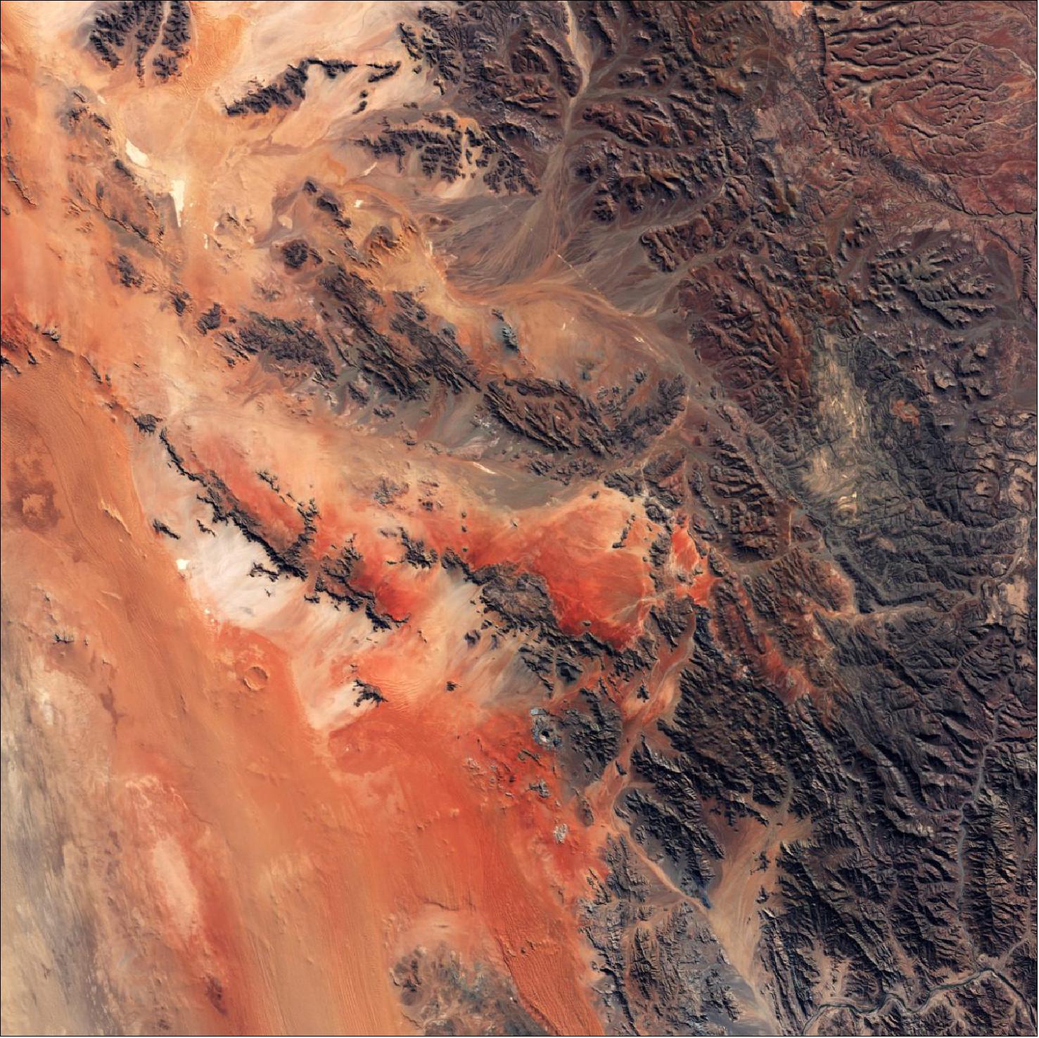Figure 28: Image of the Roter Kamm impact crater in Namibia, acquired with Sentinel-2. The circular shape of the crater rim can be seen in the left of the image, just below the center (image credit: ESA, the image contains modified Copernicus Sentinel data (2020), processed by ESA, CC BY-SA 3.0 IGO)