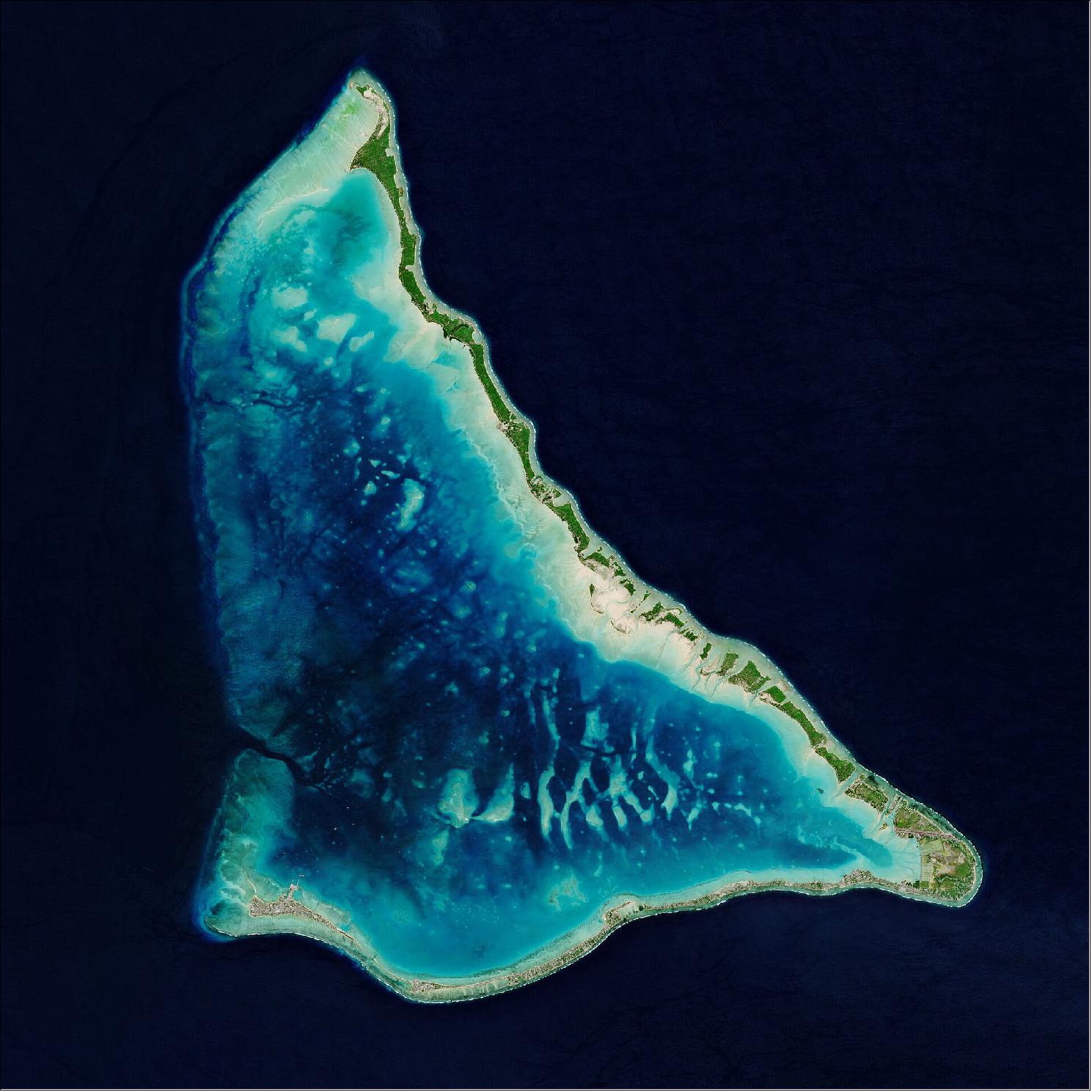 Figure 13: Tarawa Atoll, pictured here, lies approximately halfway between Hawaii and Australia. Tarawa consists of a large lagoon fringed by a V-shaped reef, around 35 km long, and is made up of more than 30 islets. Tarawa, the site of a brutal World War II battle, is divided into North and South Tarawa. This image, acquired on 14 June 2020, is also featured on the Earth from Space video program (image credit: ESA, the image contains modified Copernicus Sentinel data (2020), processed by ESA, CC BY-SA 3.0 IGO)