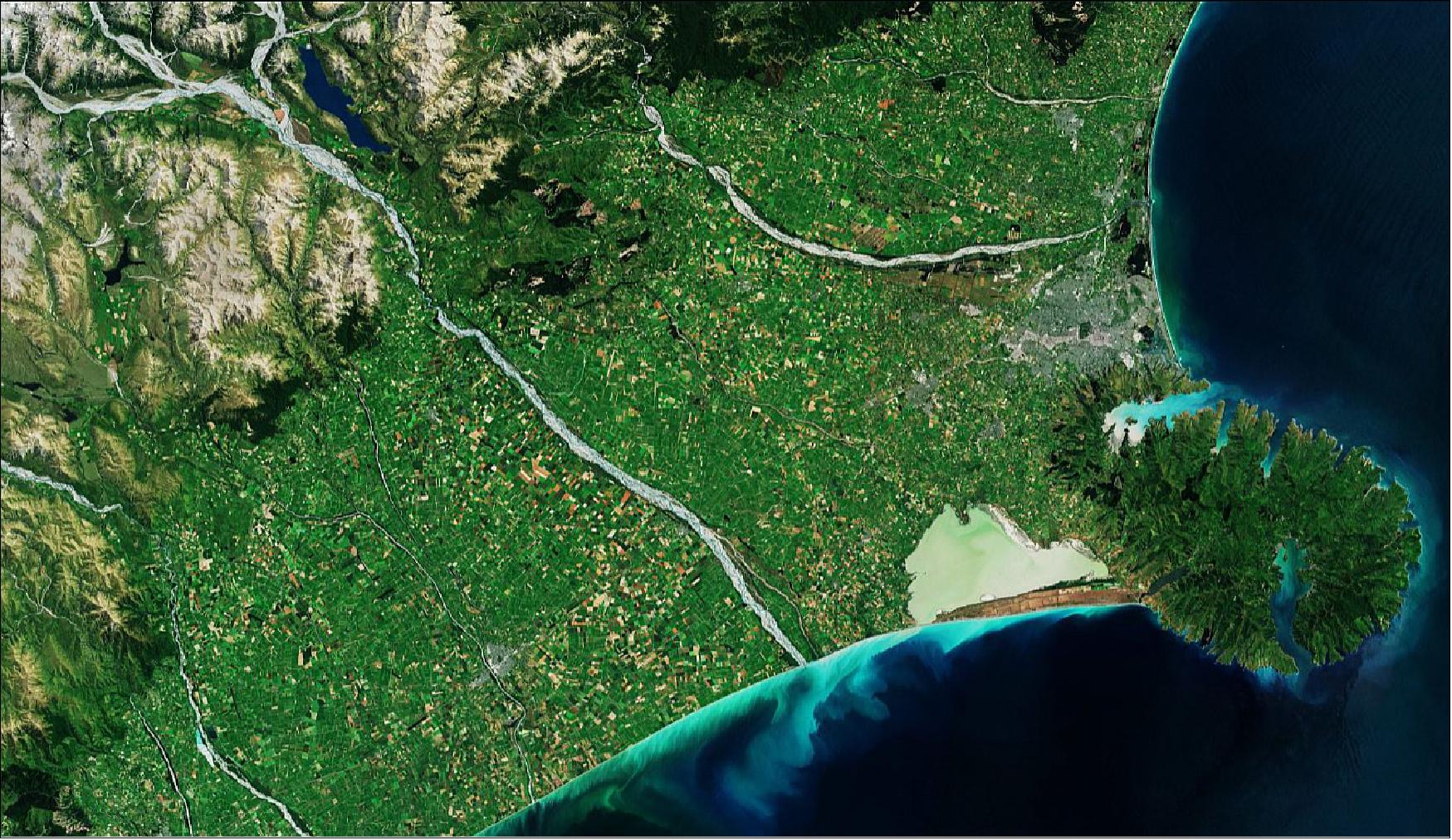 Figure 2: The Banks Peninsula's jagged coastline heavily contrasts with the adjoining, flat Canterbury Plains. Extending around 80 km inland from the coast to the foothills of the Southern Alps, visible in the top-left of the image, the plains are a rich agricultural region known for wheat and barley, as well as wool and livestock. This Sentinel-2 image, captured on 4 January 2019, is also featured on the Earth from Space video program (image credit: ESA, the image contains modified Copernicus Sentinel data (2019), processed by ESA, CC BY-SA 3.0 IGO)