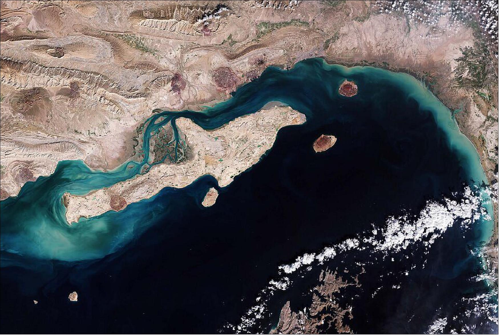Figure 48: The Sentinel-2 image shows the largely arid land surfaces on both Qeshm Island and mainland Iran. The island generally has a rocky coastline except for the sandy bays and mud flats that fringe the northwest part of the island. This image is also featured on the Earth from Space video program (image credit: ESA the image contains modified Copernicus Sentinel data (2020), processed by ESA, CC BY-SA 3.0 IGO)