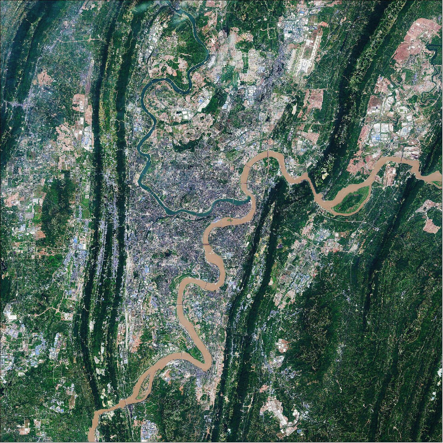 Figure 40: The city of Chongqing lies at the confluence of the Yangtze and Jialing rivers, where the clashing colors of the rivers meet. The Yangtze river is visible in brown in the right of the image, while the green waters of the Jialing can be seen in the left. The rivers make Chongqing China's biggest port city in the southwest region. With a length of 6300 km, the Yangtze is the longest river in both China and Asia and the third longest river in the world. The Jialing River, rises in the Qin Mountains, and joins the Yangtze after a course of around 1190 km. This image is also featured on the Earth from Space video program (image credit: ESA, the image contains modified Copernicus Sentinel data (2018), processed by ESA, CC BY-SA 3.0 IGO)