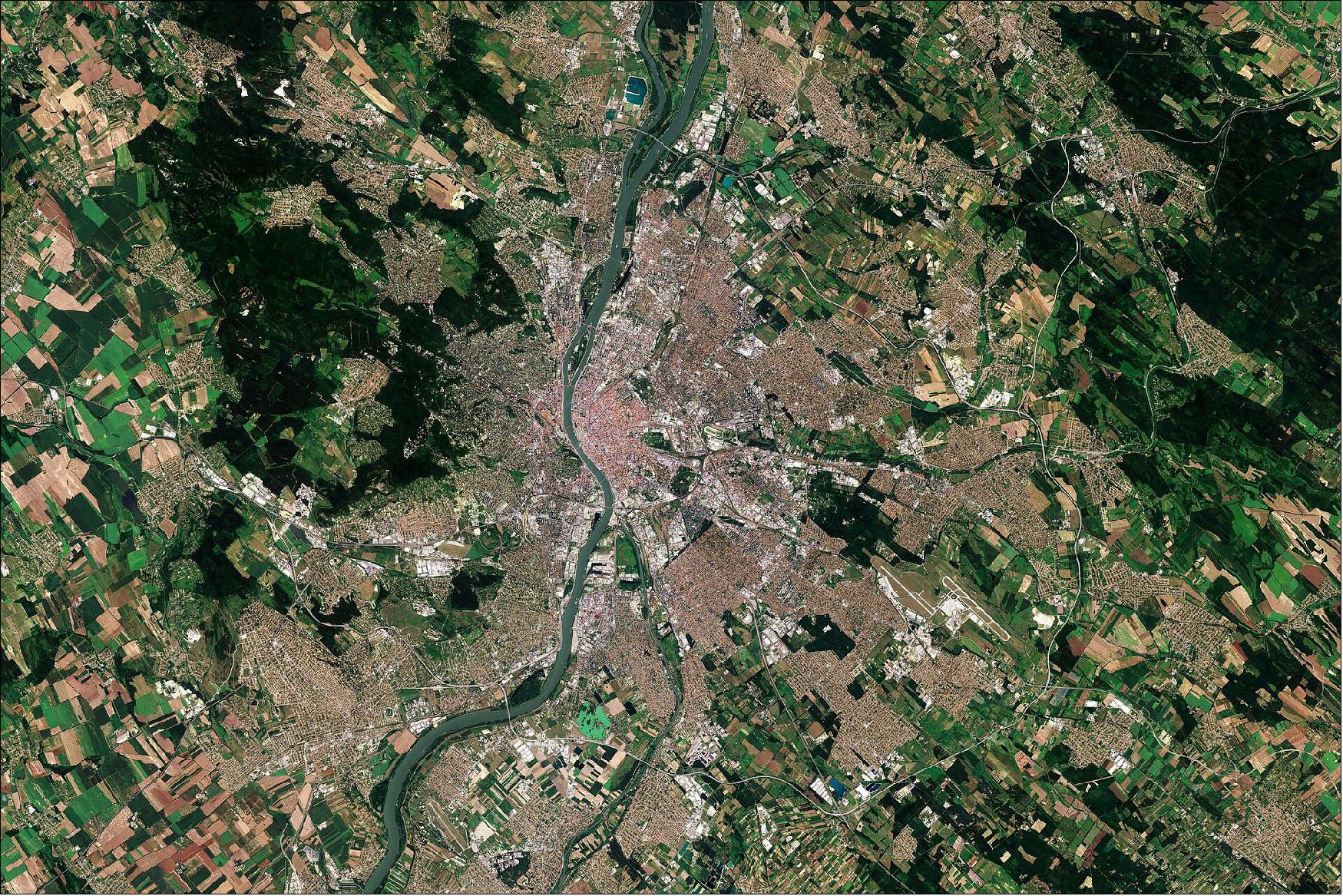 Figure 17: Budapest, which covers an area of around 525 km2, lies at the center of the Carpathian Basin, in central Hungary. In this image, captured on 28 July 2020, Budapest appears reddish in color in the center and the city is surrounded by green and beige colored fields. This image is also featured on the Earth from Space video program (image credit: ESA)