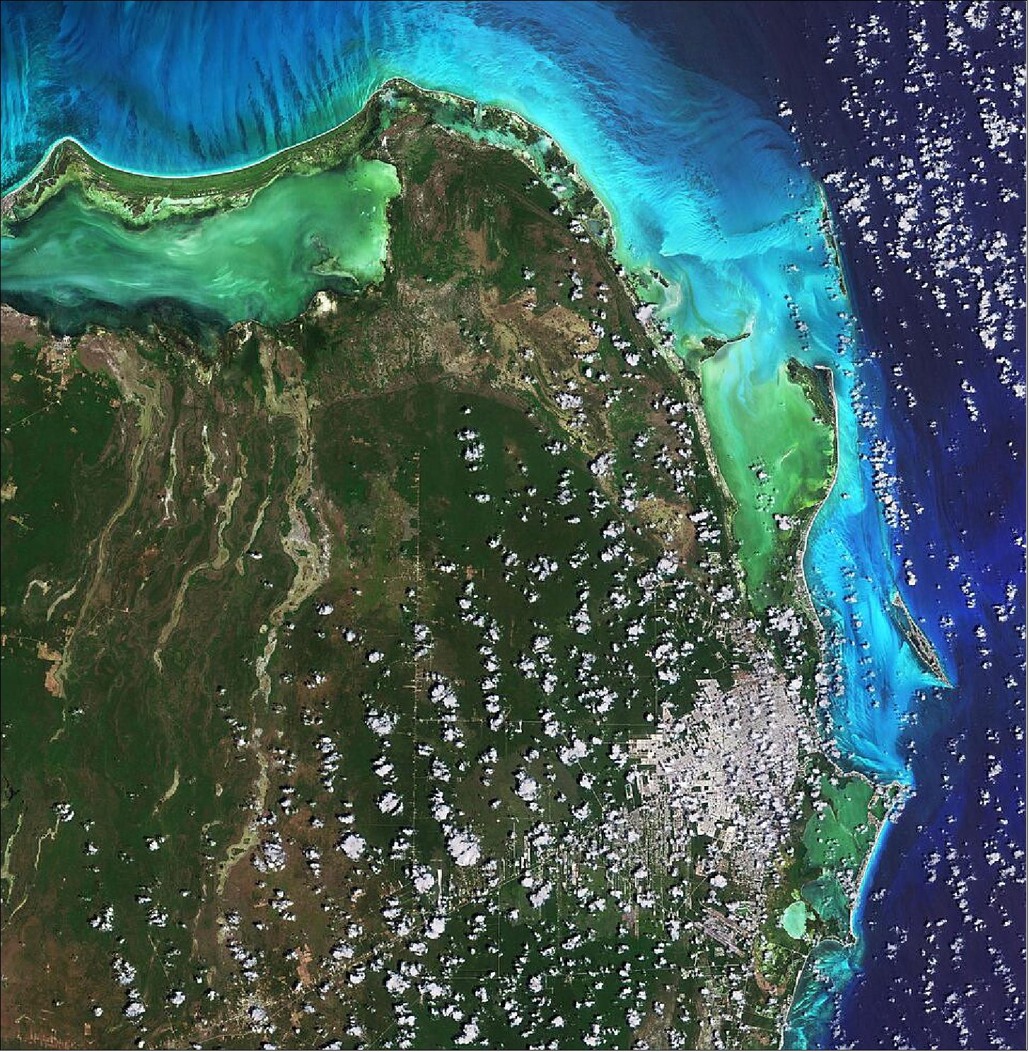 Figure 9: This image of Cancún on the Caribbean Sea was captured on 16 April 2021 by the Sentinel-2 mission. The color of the water in the image varies from emerald green to turquoise owing to the changing water depths along the coast, turbidity and differences on the ocean floor – from sand to seaweed to rocky areas. The image is also featured on the Earth from Space video program (image credit: ESA)
