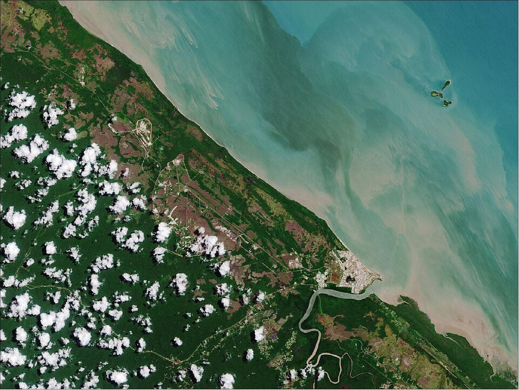 Figure 1: Located around 60 km northwest of the French Guyanese capital Cayenne, Kourou is a coastal town in the north-central part of the country and is visible in the lower right of the image. The town lies at the estuary of the Kourou River which, after its journey of 144 km, empties into the Atlantic Ocean. Its muddy waters appear brown most likely due to sediments picked up from the surrounding forest. This image is also featured on the Earth from Space video program (image credit: ESA)