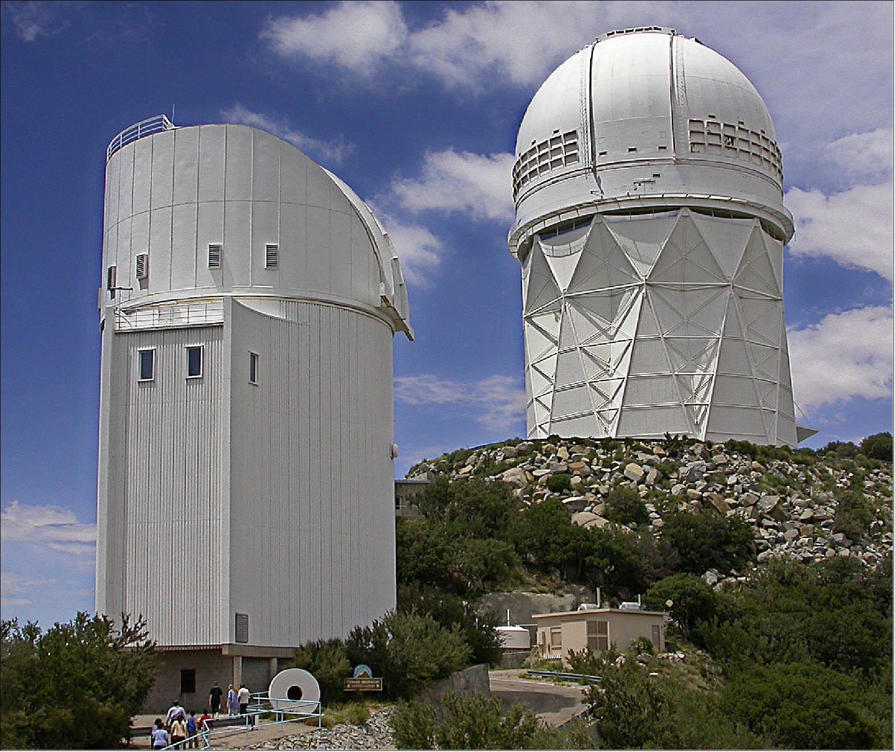 Figure 3: The Bok (left) and Mayall telescopes at Kitt Peak National Observatory near Tucson, Arizona. DESI is currently under installation at the Mayall telescope (elevation of 2096 m), image credit: Michael A. Stecker
