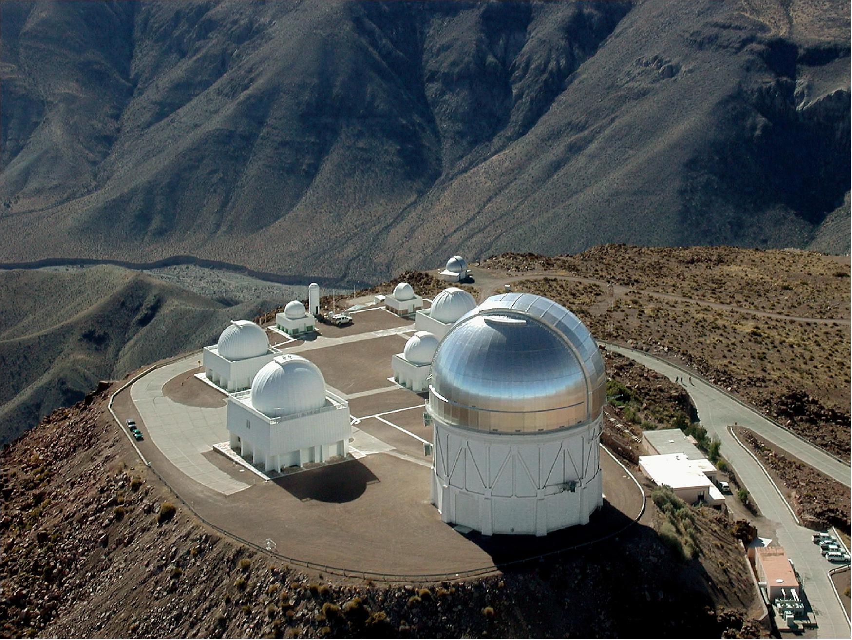 Figure 2: An aerial image of the Cerro Tololo Interamerican Observatory in Chile, with the silvery dome of the 4-meter Blanco telescope pictured at lower right (image credit: NOAO/AURA/NSF)