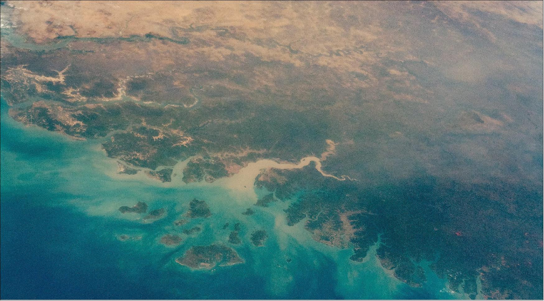 Figure 63: An astronaut aboard the International Space Station (ISS) took this oblique photograph that shows most of the West African country of Guinea-Bissau, along with neighboring Guinea, The Gambia and Senegal, and the southern part of Mauritania. This scene stretches from the green forest vegetation and wet climates of the Atlantic coast to the almost vegetation-less landscapes of the Sahara Desert (image credit: NASA)