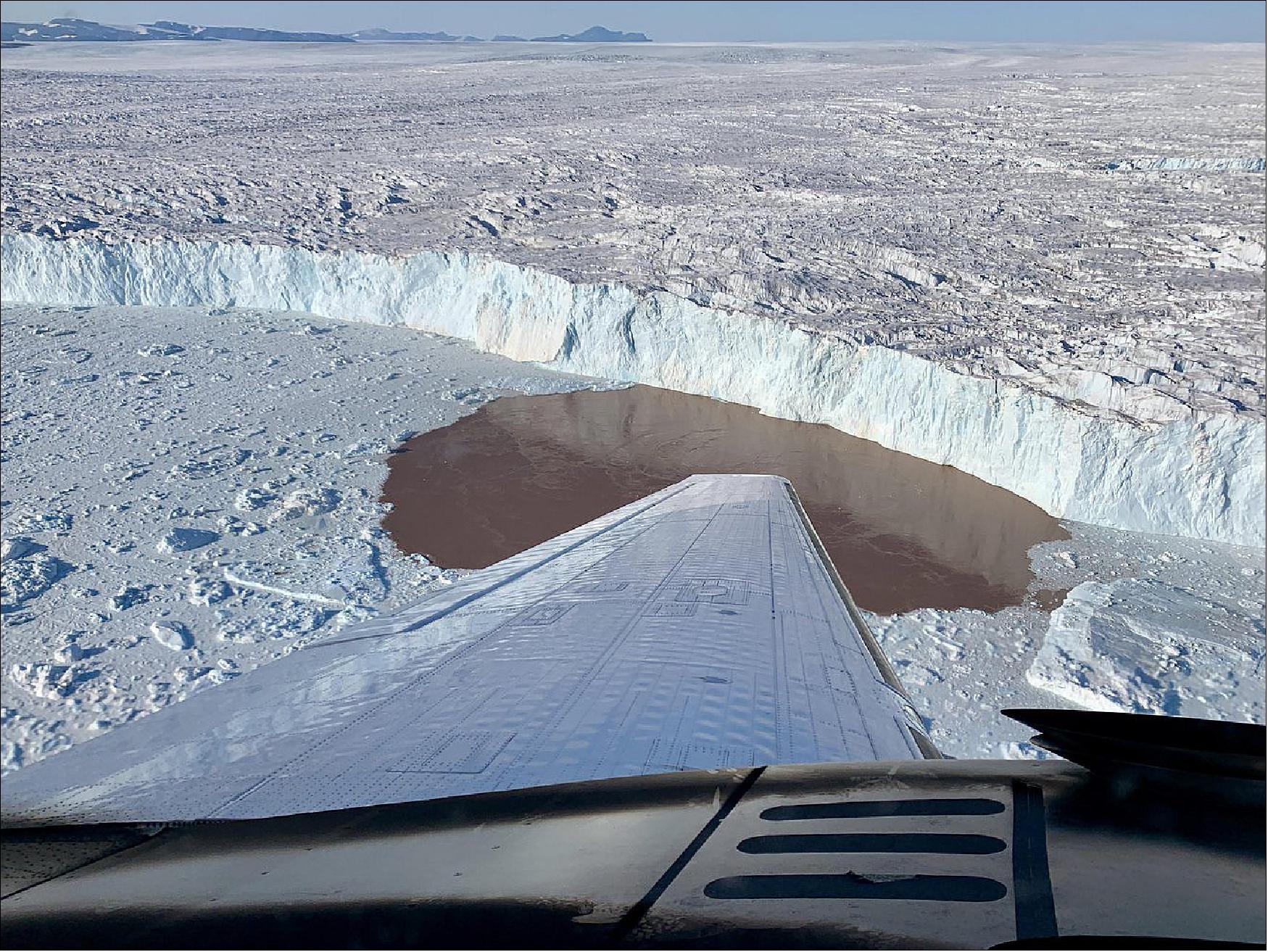 Figure 40: To measure water depth and salinity, the OMG project dropped probes by plane into fjords along Greenland's coast. Shown here is one such fjord in which a glacier is undercut by warming water (image credit: NASA/JPL-Caltech)