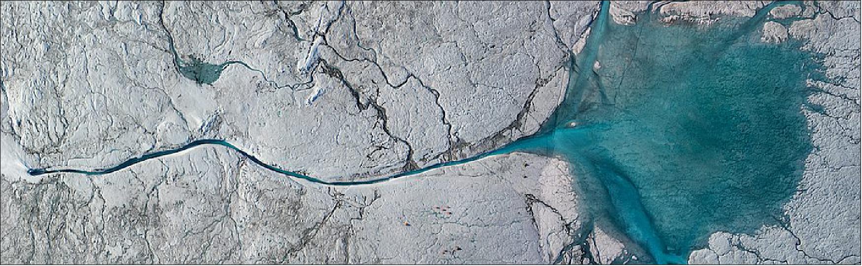 Figure 37: At the fringes of the Greenland Ice Sheet, where glaciers are constantly melting, water rushes everywhere through an intricate system of lakes and streams that branch out like slip and slide shoots of super chilled, bright turquoise water. Some of that water eventually cascades straight into the surrounding land and ocean through channels and cracks. Some of it thunders off into sinkhole-like structures on the ice called moulins. Rumbling 24 hours a day, these holes swallow water from the surface and funnel it to the bedrock at the base of the ice (image credit: Laurence C. Smith)