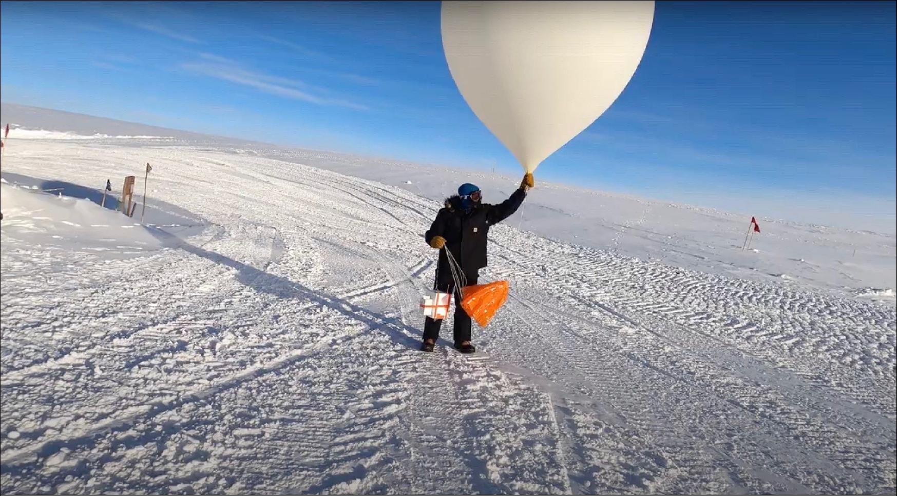 Figure 13: A scientist launches a weather balloon carrying an ozonesonde from the South Pole Station in March of 2021 (image credits: NOAA Global Monitoring Laboratory)