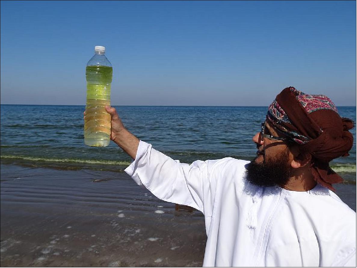 Figure 82: Coauthor Khalid Al-Hashmi of Oman's Sultan Qaboos University holds a Noctiluca-fouled bottle of seawater (photo credit: Columbia University/Lamont-Doherty Earth Observatory, Joaquim Goes)