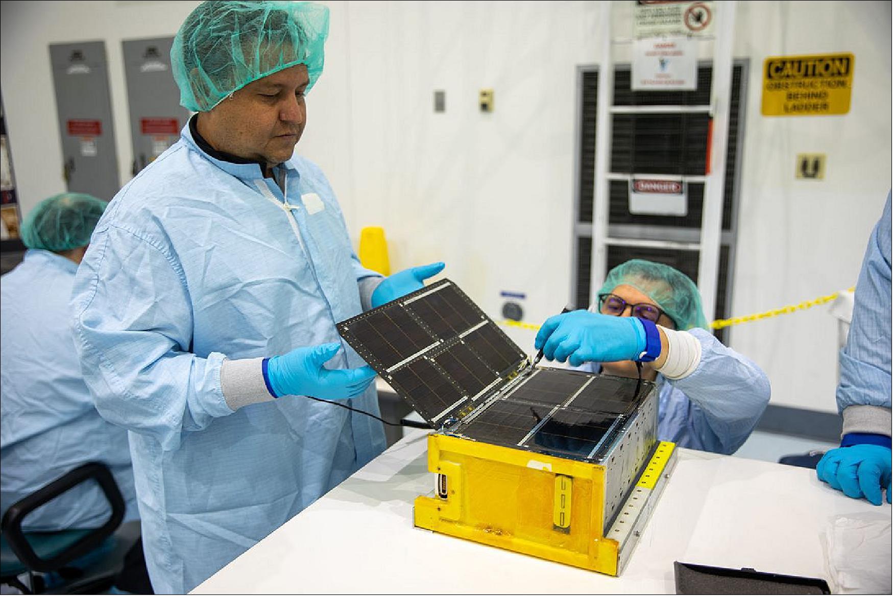 Figure 9: Team Miles works in a clean room at NASA’s Kennedy Space Center in Florida to prepare their CubeSat to be launched on the Artemis I mission. The team designed the satellite to travel farther than this size of craft has ever gone – 59.6 million miles (96 million km) – before ending its mission. The CubeSat was developed as part of NASA’s Cube Quest Challenge and sponsored by Space Technology Mission Directorate (STMD) Prizes, Challenges, and Crowdsourcing program(image credit: Team Miles)