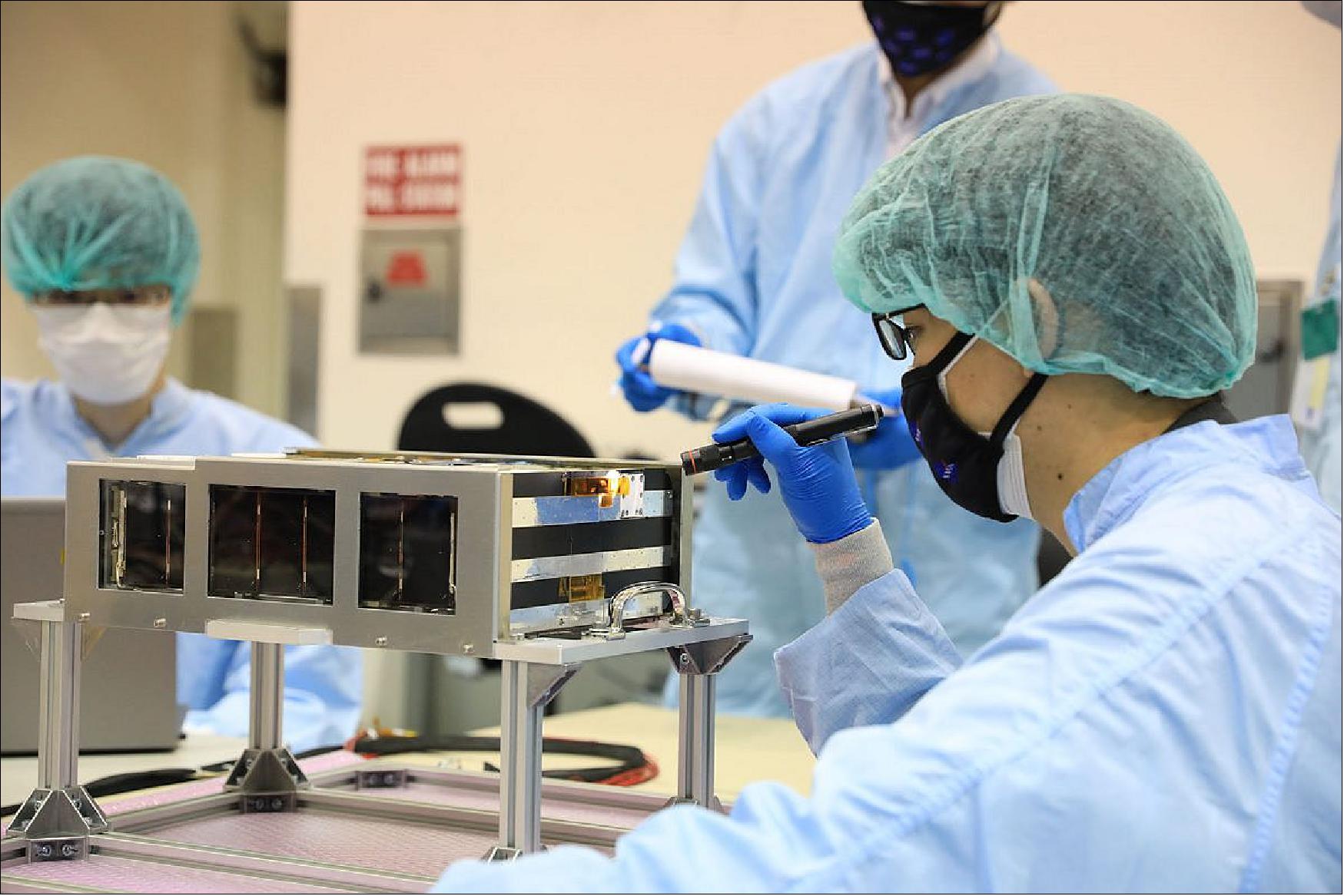 Figure 8: Members of the EQUULEUS (EQUilibriUm Lunar-Earth point 6U Spacecraft) team prepare their CubeSat to be loaded in the Space Launch System’s Orion stage adapter for launch on the Artemis I mission. This CubeSat, developed jointly by the Japan Aerospace Exploration Agency (JAXA) and the University of Tokyo, will help scientists understand the radiation environment in the region of space around Earth called the plasmasphere (image credit: ISSL, JAXA)