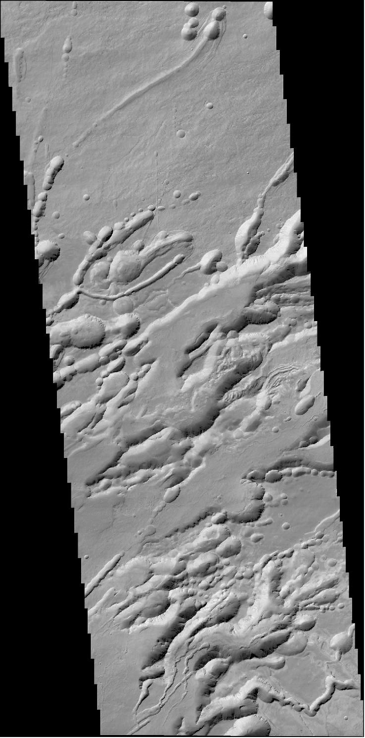 Figure 117: A 25 km-wide image strip over a structure called Arsia Chasmata, which lies on the flank of the large volcano Arsia Mons. The formation is volcanic in origin and many pit craters, possibly caused by subsidence, can be seen. The image was taken on 22 November 2016 and is one of the first acquired by the CaSSIS (Color and Stereo Surface Imaging System) onboard the ExoMars Trace Gas Orbiter. The image was taken as part of an eight-day campaign to test the science instruments for the first time since arriving at the Red Planet on 19 October [image credit: ESA/Roscosmos/ExoMars/CaSSIS/UniBE; mosaicking tool: AutoStitch (University of British Columbia)]