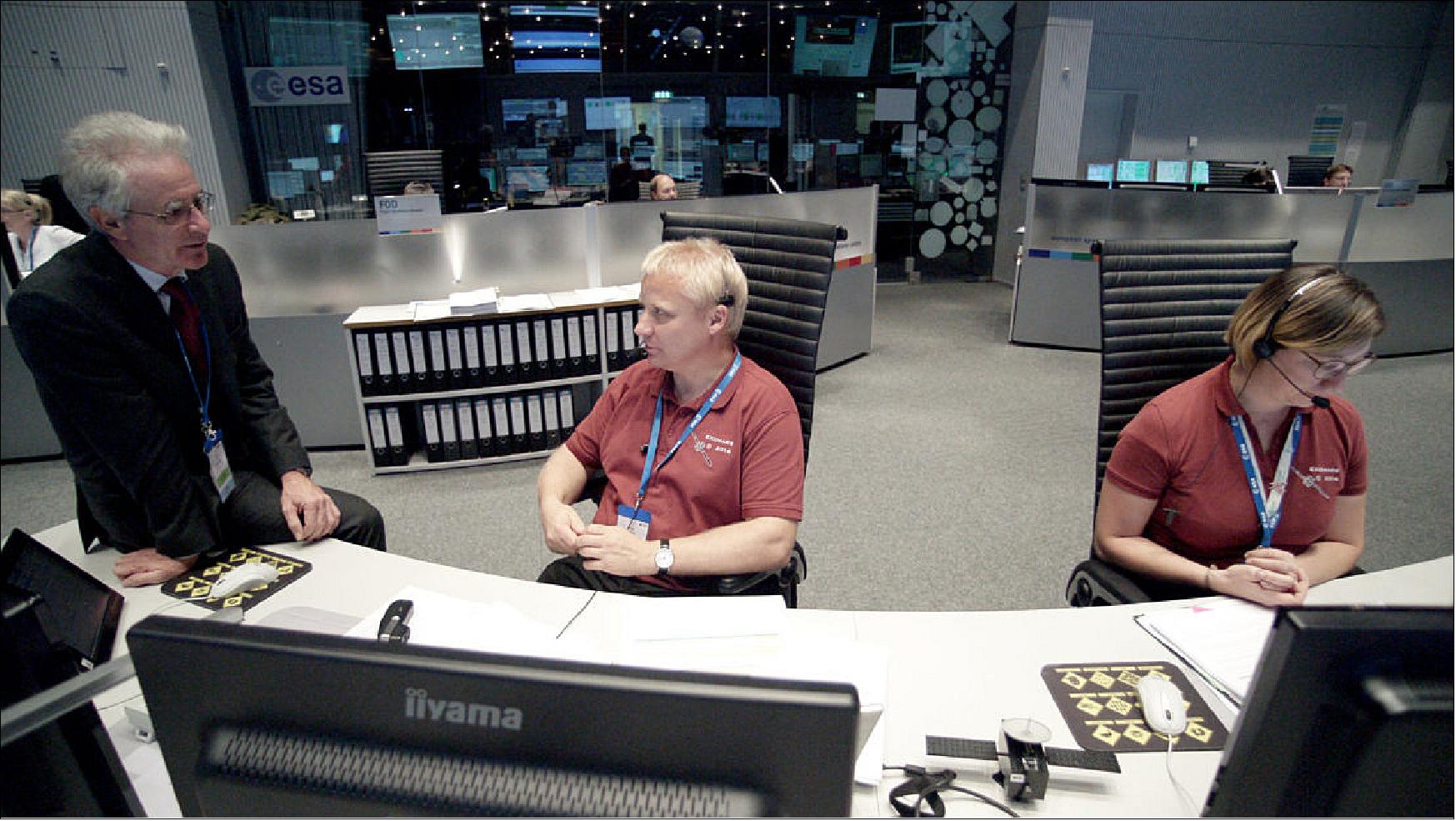 Figure 114: ExoMars Trace Gas Orbiter Spacecraft Operations Manager Peter Schmitz, center, in discussions with ESA’s Head of Mission Operations, Paolo Ferri, at left, during the arrival of TGO at Mars on 19 October 2016. Deputy Spacecraft Operations Manager Silvia Sangiorgi is working at the console at right (image credit: ESA, P. Shlyaev)