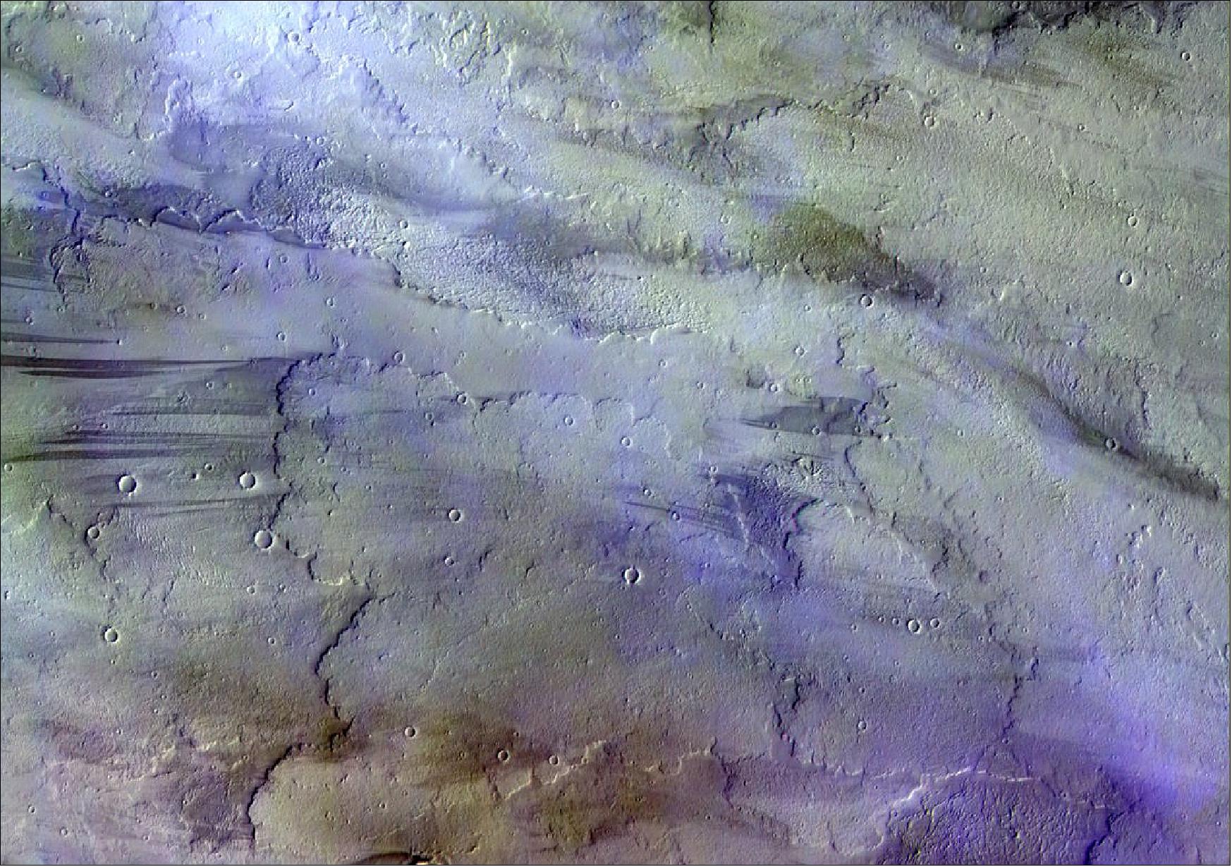 Figure 100: A cloudy day over volcanic Mars, captured by the ExoMars orbiter. Clouds, most likely of water-ice, and atmospheric haze in the sky are colored blue/white in this image (image credit: ESA/Roscosmos/CaSSIS, CC BY-SA 3.0 IGO)