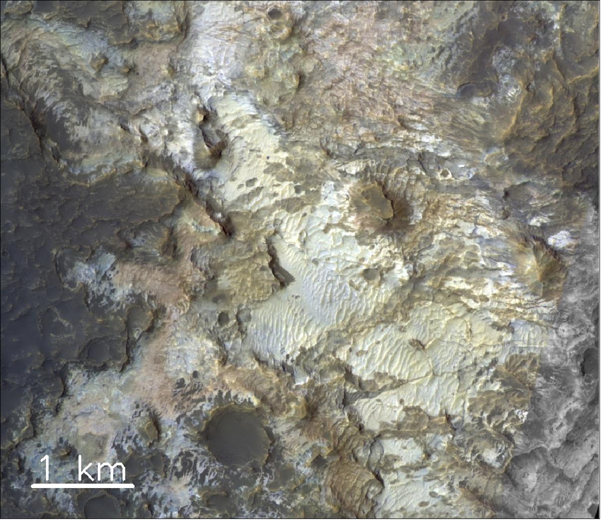 Figure 78: The subtle tints seen in this color-composite image of the floor of Kibuye crater on Mars, in the region of Terra Sirenum, highlight the rich variety of mineralogical composition found in these rocks. The image was taken by the CaSSIS instrument onboard the ESA-Roscosmos ExoMars TGO on 15 December 2018. Chloride salt and clay minerals have been identified here from orbit in the past by infrared spectrometers. CaSSIS color-composite images processed like this one allow scientists to refine the mapping of Mars mineralogy at higher spatial scales. In this region, for example, there is strong evidence for sustained weathering of the rocks by water and possible ancient lakes. Such color-composite images illustrate the extraordinary sensitivity of CaSSIS to the mineralogical composition of the rocks. The image is centered at 29.1ºS/178.2ºE (image credit: ESA/Roscosmos/CaSSIS, CC BY-SA 3.0 IGO)