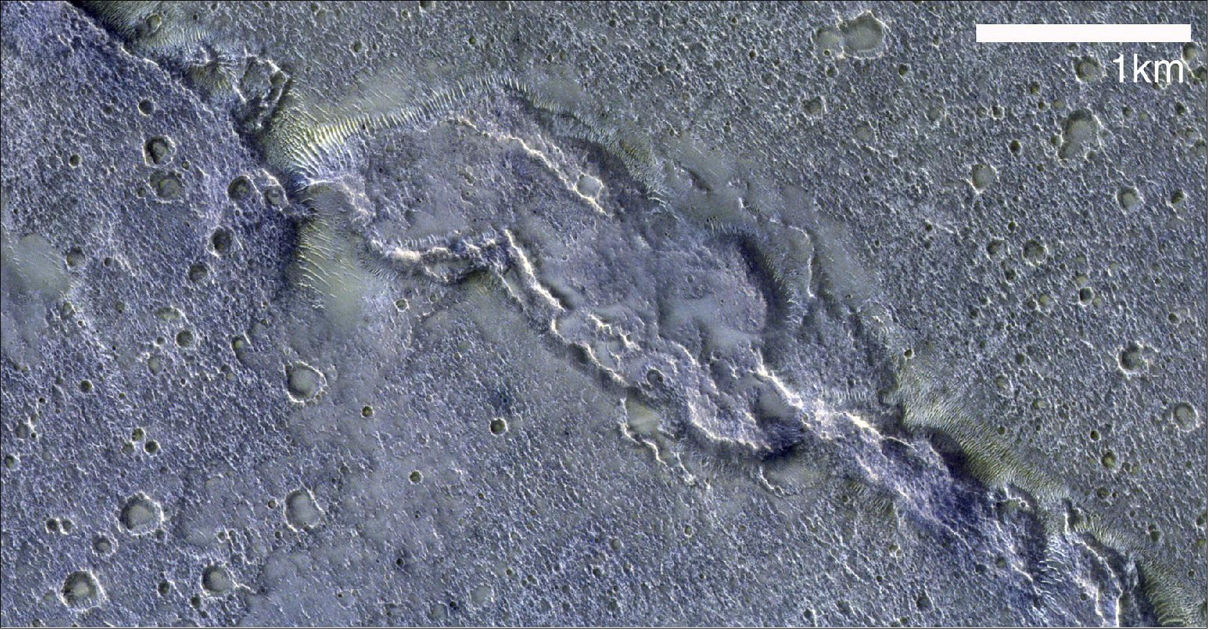 Figure 39: The image, taken on 13 December 2020, features Solis Dorsum, a segment of a prominent wrinkle ridge system in a vast volcanic plateau, known as Tharsis. Wrinkle ridges are tectonic features that form in layered basalt lavas due to loading and flexure of the planet's crust and upper mantle. These tectonic stresses are caused by the planet's interior cooling and subsequent contraction (image credit: ESA/Roscosmos/CaSSIS, CC BY-SA 3.0 IGO)