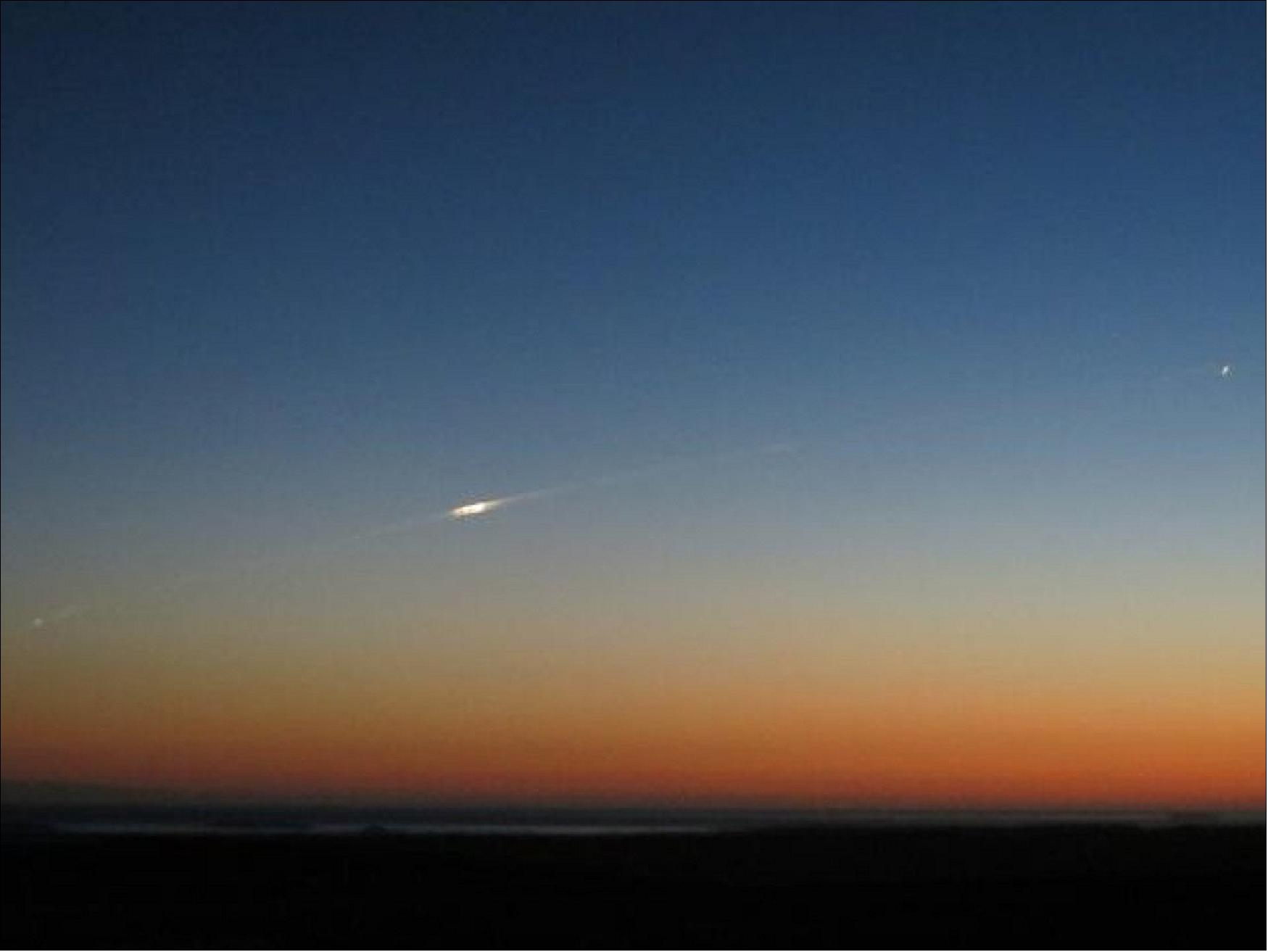 Figure 31: Photo of GOCE reentering the atmosphere taken by Bill Charter in the Falklands at 21:20 local time on 11 November. Posted on Twitter, Bill wrote, "Driving southwards at dusk, it appeared with bright smoke trail and split in 2 before splitting again into more and going on north." (image credit: Bill Carter)