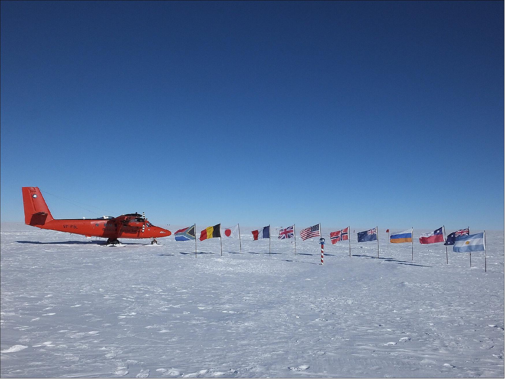 Figure 23: Survey aircraft at the South Pole. An ESA-funded study called PolarGAP can now lay some of this conjecture to rest. Using sensors on aircraft to measure changes in the gravity and magnetic signatures of the different rocks under the ice, scientists have discovered a huge bay the size of the UK formed part of the edge of East Antarctica. The image shows a PolarGAP campaign survey aircraft at the South Pole (image credit: BAS)