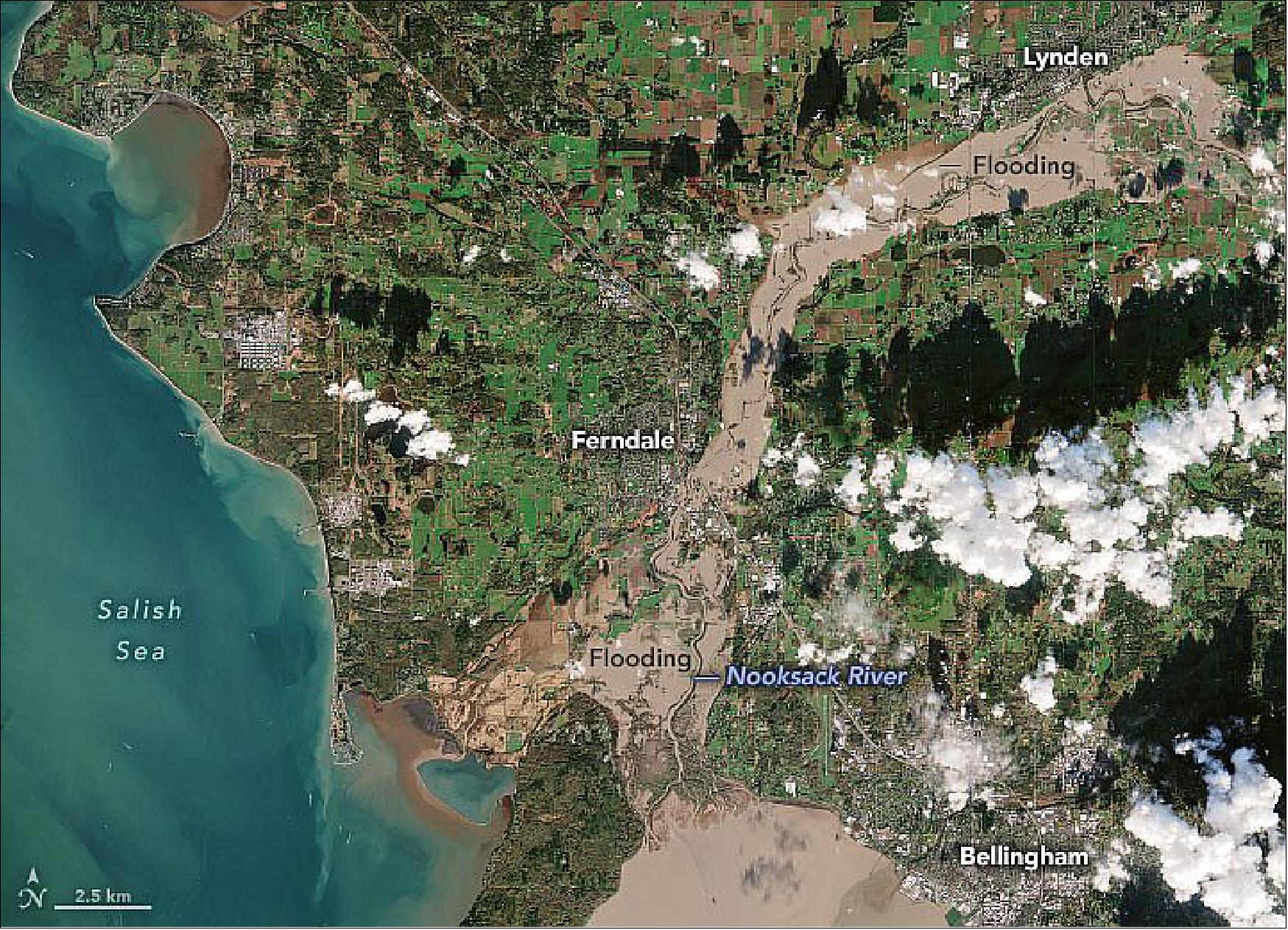 Figure 16: Flooding along Washington’s Nooksack River is visible in this natural-color image, acquired on November 16, 2021, by the European Space Agency’s Copernicus Sentinel-2 mission. On this day, the river crested at 7.24 meters (23.76 feet), short of the highest crest on record (31.23 feet in February 1951) but still higher than the river has risen in decades. From Lynden to Ferndale to the mouth of the river at Bellingham Bay, floodwaters inundated neighborhoods, businesses, and farmland. In Whatcom County, 500 people evacuated their homes (image credit: NASA Earth Observatory)