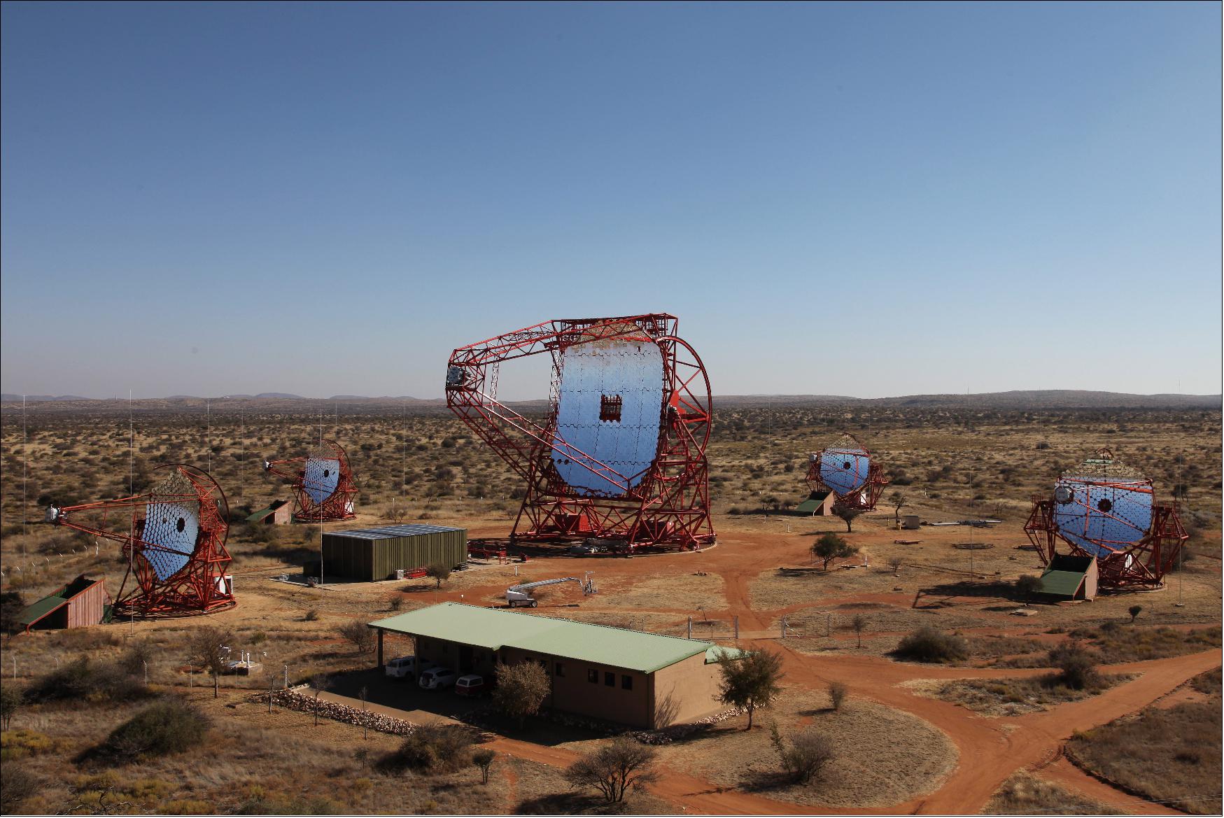 Figure 3: View of the full H.E.S.S. array with the four 12 m telescopes and the new 28 m H.E.S.S. II telescope in Namibia (image credit: H.E.S.S. Collaboration, Clementina Medina, Ref. 6)