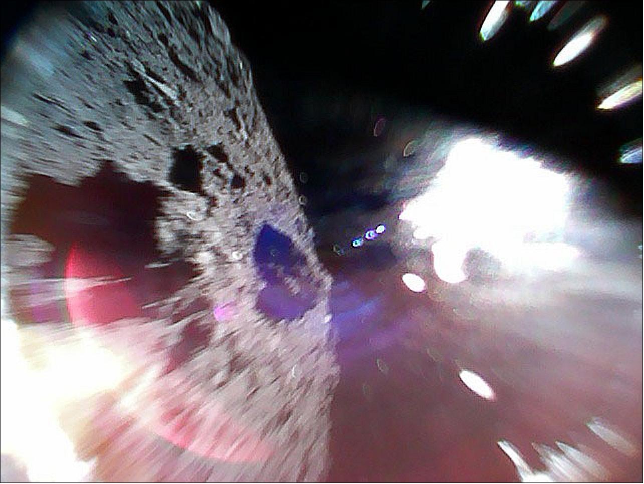 Figure 95: Image captured by Rover-1A on September 22 at around 11:44 JST. Color image captured while moving (during a hop) on the surface of Ryugu. The left-half of the image is the asteroid surface. The bright white region is due to sunlight (image credit: JAXA)
