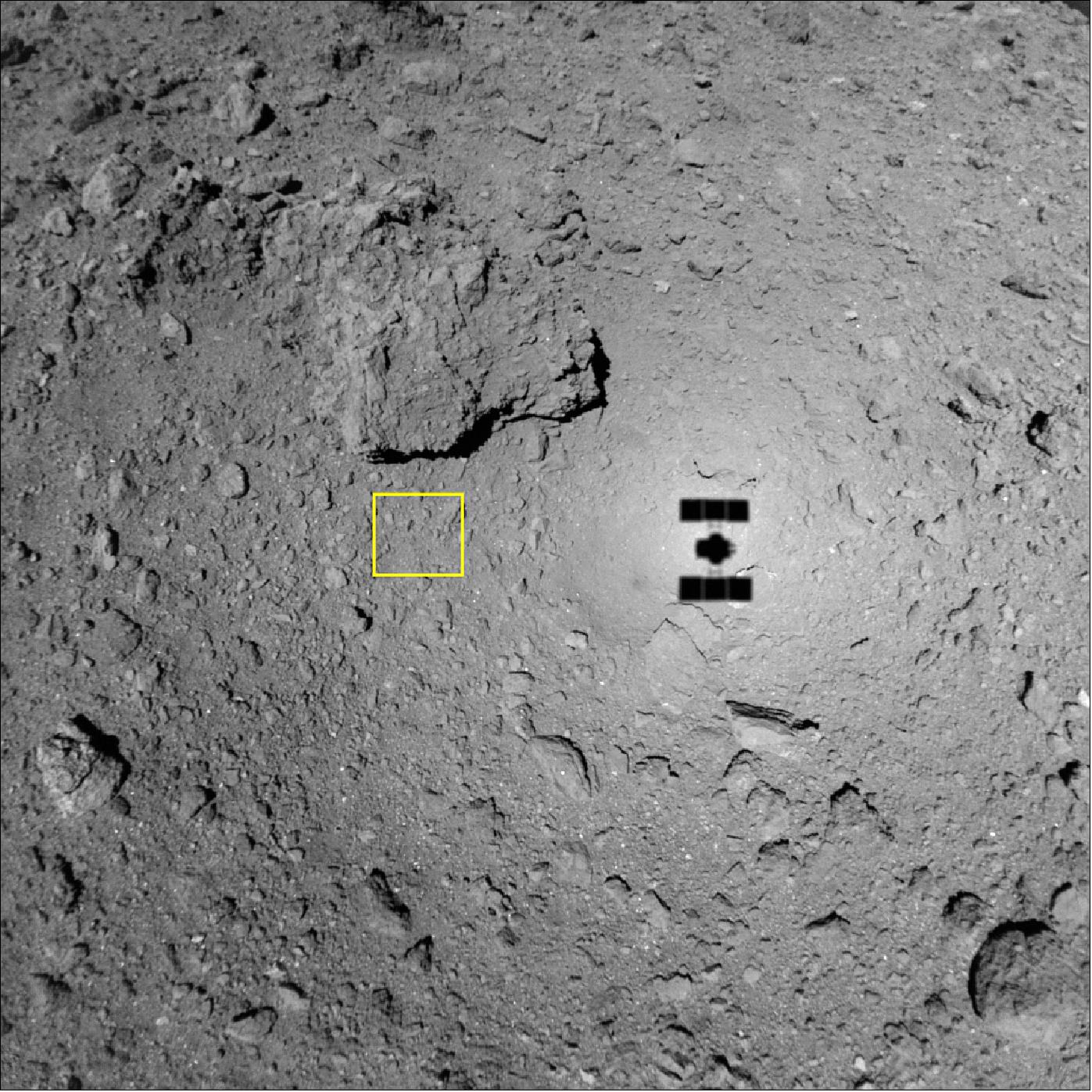 Figure 75: Surface of Ryugu photographed by the ONC-W1 at an altitude of about 49m. The image was captured on October 15, 2018 at 22:39 JST. The yellow square indicates the image area in Figure 74 (image credit: JAXA, University of Tokyo, Kochi University, Rikkyo University, Nagoya University, Chiba Institute of Technology, Meiji University, University of Aizu, AIST)