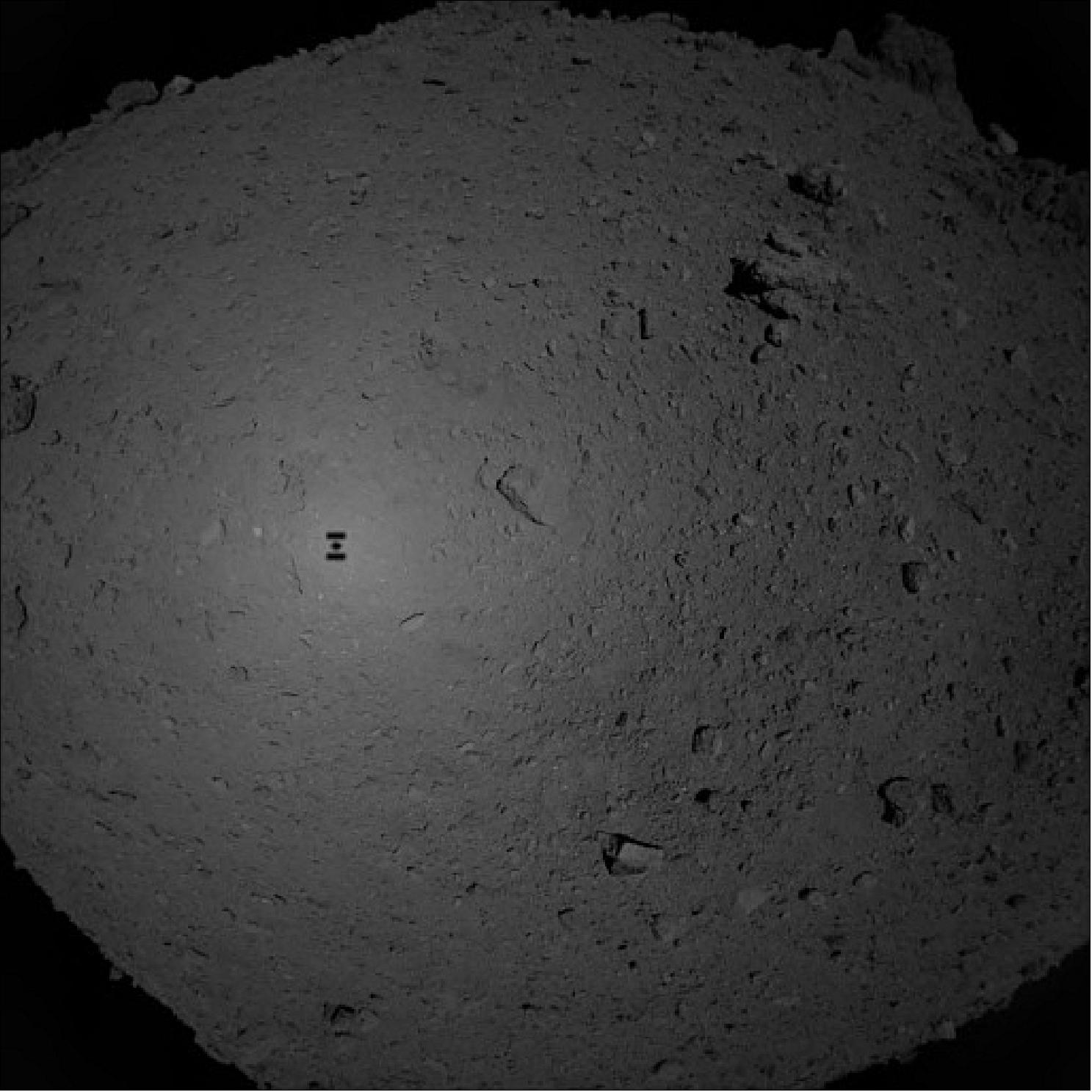 Figure 64: Hayabusa-2 photo of Ryugu during sampling descent. Hayabusa-2 took this photo with its optical navigation camera at an altitude of about 180 meters, before it entered its final descent to grab a sample from asteroid Ryugu, on 21 February 2019 (image credit: JAXA, University of Tokyo, Kochi University, Rikkyo University, Nagoya University, Chiba Institute of Technology, Meiji University, University of Aizu, AIST)
