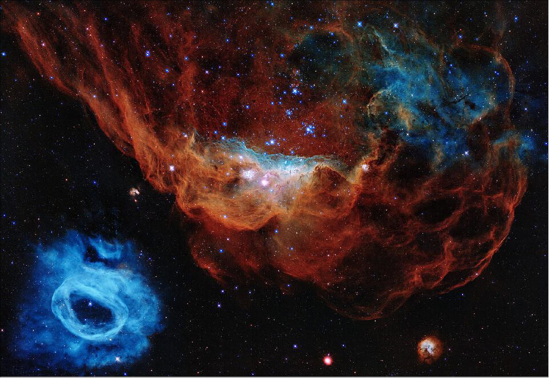 Figure 69: Hubble Space Telescope’s iconic images and scientific breakthroughs have redefined our view of the Universe. To commemorate three decades of scientific discoveries, this image is one of the most photogenic examples of the many turbulent stellar nurseries the telescope has observed during its 30-year lifetime. The portrait features the giant nebula NGC 2014 and its neighbor NGC 2020 which together form part of a vast star-forming region in the Large Magellanic Cloud, a satellite galaxy of the Milky Way, approximately 163 000 light-years away. The image is nicknamed the “Cosmic Reef” because it resembles an undersea world (image credit: NASA, ESA, and STScI; CC BY 4.0)