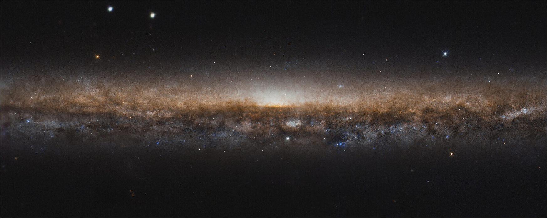Figure 52: The Knife Edge Galaxy is about 50 million light-years from Earth, lying in the northern constellation of Draco. Although not visible in this image, ghostly streams of stars on large arching loops extend into space, circling around the galaxy; they are believed to be remnants of a small dwarf galaxy, torn apart by the Knife Edge Galaxy and merged with it over four billion years ago [image credit: ESA/Hubble & NASA, R. de Jong; CC BY 4.0; Acknowledgement: Judy Schmidt (Geckzilla)]