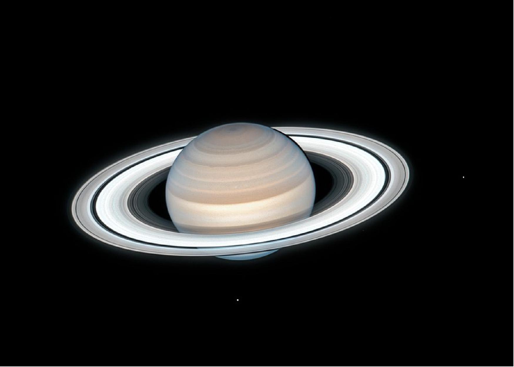 Figure 45: NASA's Hubble Space Telescope captured this image of Saturn on July 4, 2020. Two of Saturn's icy moons are clearly visible in this exposure: Mimas at right, and Enceladus at bottom. This image is taken as part of the Outer Planets Atmospheres Legacy (OPAL) project. OPAL is helping scientists understand the atmospheric dynamics and evolution of our solar system's gas giant planets. In Saturn's case, astronomers continue tracking shifting weather patterns and storms (image credits: NASA, ESA, A. Simon (Goddard Space Flight Center), M.H. Wong (University of California, Berkeley), and the OPAL Team)